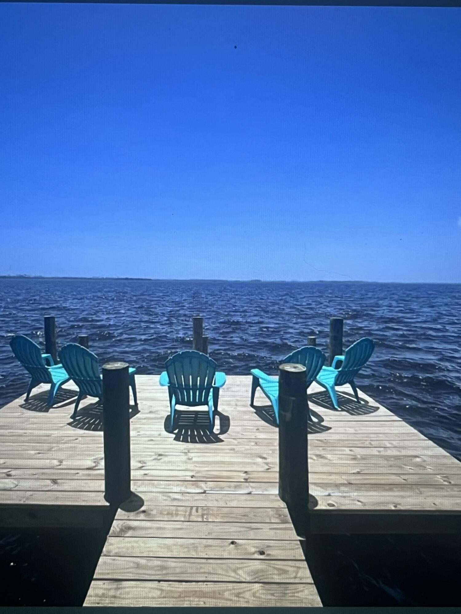 BAY FRONT/PRIVATE BOAT LAUNCH/GUEST HOUSE/HOT TUB/-Enjoy living on the bay for less than a million and No HOA! The home is currently a vacation rental, but could also serve as a primary residence or a second home. This gorgeous property with majestic southern live oak trees even comes with its own boat launch, so you don't have to drive to launch your boat. 155 feet of waterfront with 0.89 of an acre with sunrises and sunsets that will leave you breathless! The main solid brick house is 1852 sq. ft. with 3 bedrooms and 2 baths. The guest house is 504 square feet with one bedroom and one bathroom. The main house and guest house have been updated. The living area has beamed ceilings, LVP, and tile flooring throughout. The chef's kitchen is appointed with a gas stove, white cabinets, and black Suede countertops, Thermador double ovens, tons of cabinets, stainless steel appliances, and a farm sink. A large breakfast bar for informal meals, and the dining area is large enough to seat the whole family. The open great room has floor-to-ceiling windows that overlook the bay with shiplap walls, pickled wood planking, and an open beamed ceiling. The living area is graced with a gas fireplace with German Schmear brick surround and eye-catching mantle. This home, with its open spaces, is perfect for entertaining. All the bedrooms have built-ins, closets, and drawers for storage. The owner's suite has a walk-in closet with a secondary step-in closet. The owner's bathroom has double sinks with a large tiled shower, a large copper soaking tub, and a sliding barn door. A large laundry room is located directly off the kitchen. The guest house has a kitchenette, full bath with tiled shower and floor, walk-in closet, and 2 lofts for loft beds. The guest house has a mini-split for controlled temperature. The garage has recently been turned into a Game Room, but can easily be converted back to a garage. This home on the bay has it all with almost an acre of land, its private boat launch/ramp, seawall, dock, hot tub, game room, and views of East Bay that are mesmerizing! Call for your appointment today! All measurements are to be verified by the buyer.