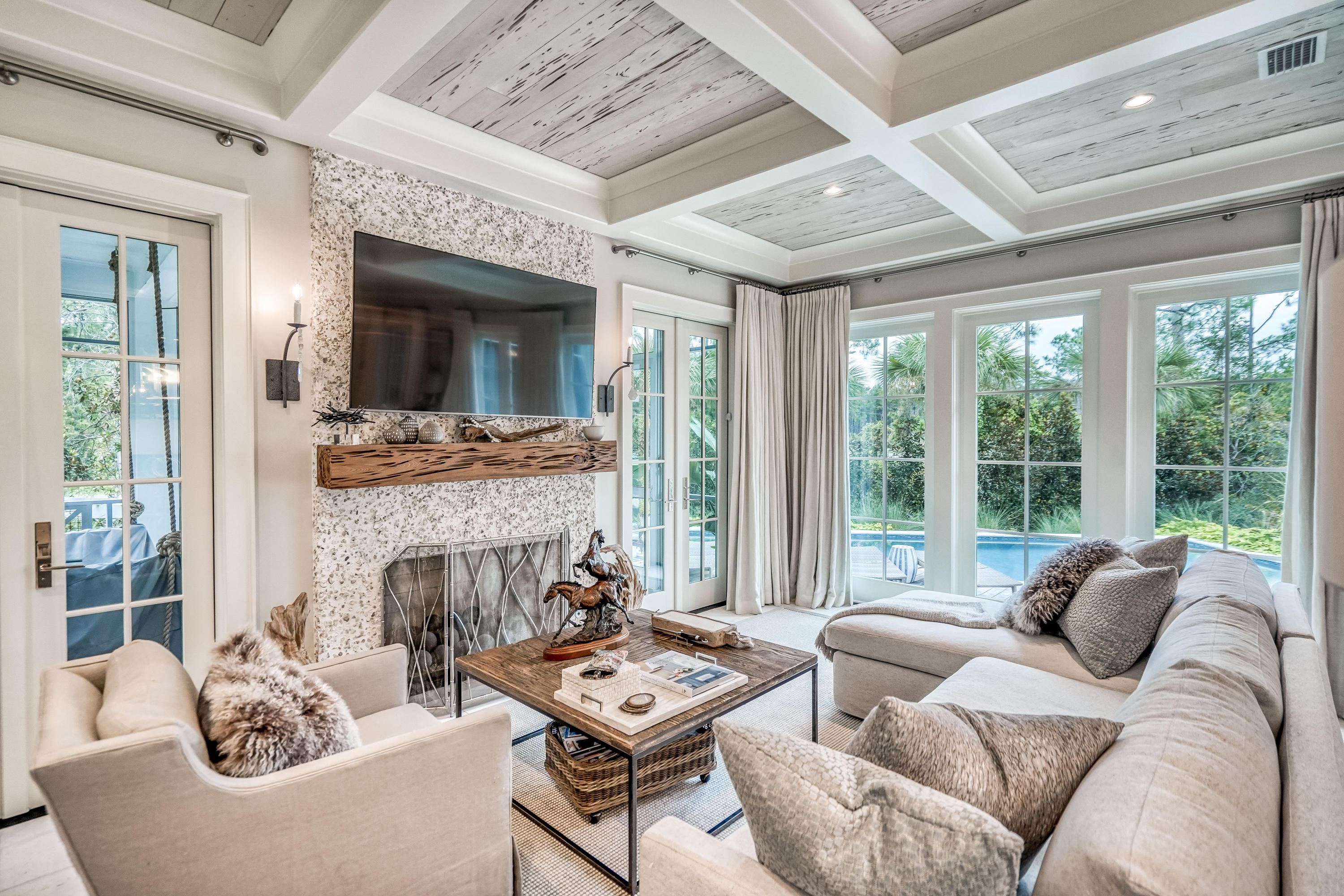 Designed by Geoff Chick & Associates and built by Dune Construction, every detail of this 4BR/4.5BA WaterSound Beach home has been carefully curated to create a truly one-of-a-kind masterpiece. Notice custom details from the moment you enter such as stunning chandeliers from Lowcountry Originals, Rice White Peacock Paver floors perfect for going straight from the beach to the private pool, Pecky Cypress and coffered ceilings, and stunning tile work. The first level includes a spacious living and dining area with ample room for entertaining including a cozy screened porch with a bed swing and a second larger screen porch overlooking the pool with a built-in grill. Boasting one of the largest private pools within the community, discover a lushly landscaped outdoor retreat with a 38' x 12'