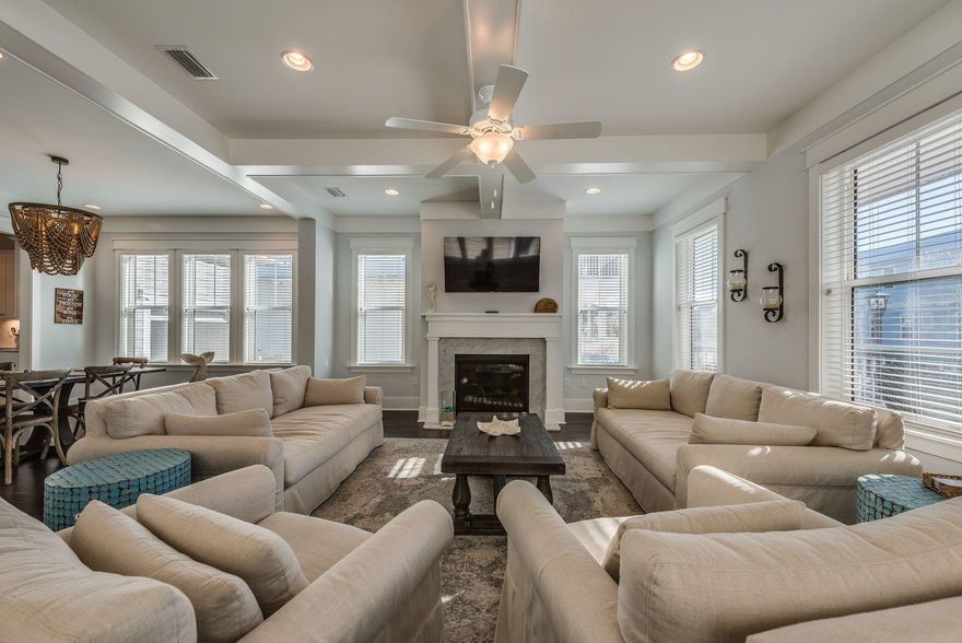 Overlooking a pond & preserve, ''Enchanting at Seagrove'' offers 4 bedrooms & 3.5 baths w/ a sprawling main floor, this Sea Glass plan is a beach home both functional and cozy. W/ upgrades galore like onyx maple wood floors, 10' white beamed ceilings, extra large eat-in kitchen w/ carrera marble island, GE Caf appliances and gas cooktop, a gas fireplace w/ marble surround in the living room, extended one car garage (for your beach toys and the included six seater golf cart!), and 3 separate screened porches, this home is sure to soothe full-time residents or vacationers in search of some beachy respite. NatureWalk is an amenity-rich community w/ pools, trails, green spaces, multi-purpose courts, and a seasonal beach shuttle running to and from the beach. Fully furnished & rental ready!