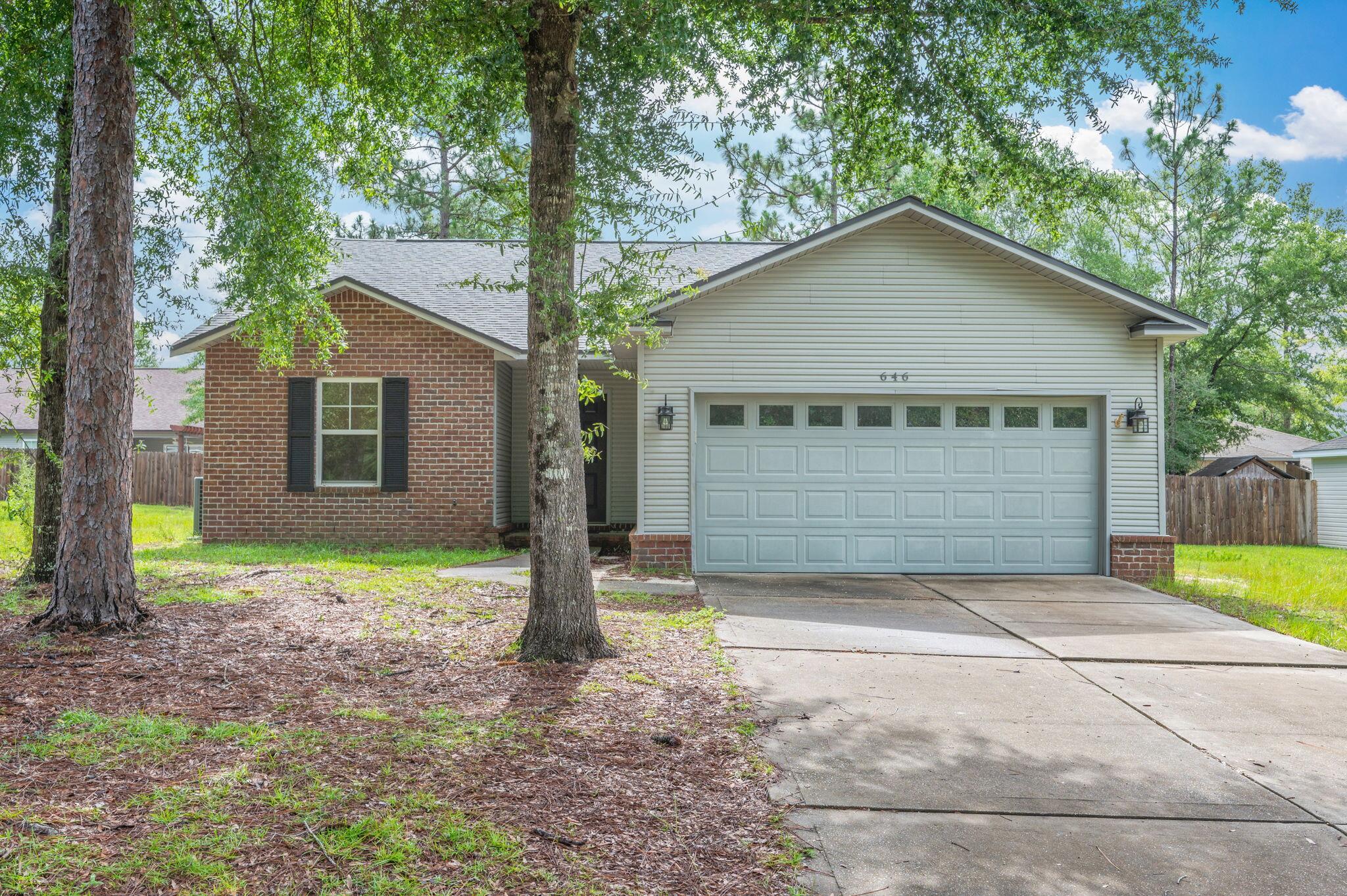 Available June 13th --this beautifully maintained 3-bedroom, 2-bath home in the private and peaceful Hunter's Ridge neighborhood offers comfort, space, and convenience all in one. Featuring 1,466 square feet, the home boasts a split floor plan, vaulted ceilings, and brand-new waterproof LVP flooring throughout. The open living, dining, and kitchen area includes a center island, pantry, and plenty of counter space--perfect for everyday living and entertaining. Enjoy a spacious covered back porch overlooking the backyard, ideal for relaxing or outdoor meals. The primary suite includes a walk-in closet and double vanity, and there's a large two-car garage and separate utility room for added convenience. Located just minutes from schools, shopping, and downtown DeFuniak Springs.
