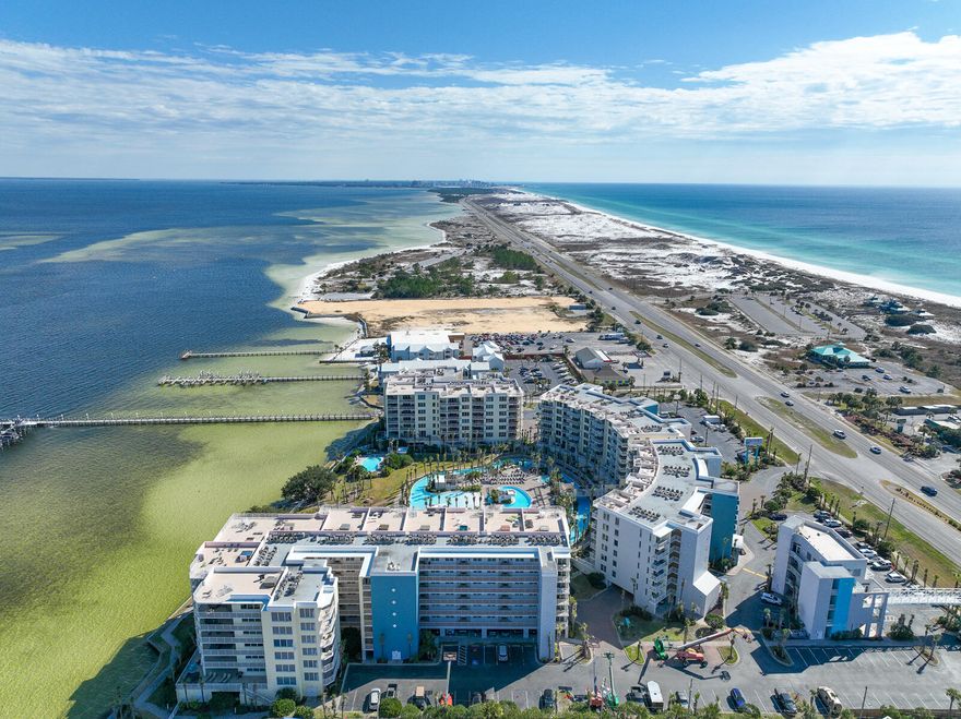 You don't want to miss this highly desirable 3 Bed/2 Bath Destin West condo!  Large kitchen with granite countertops and stainless appliances, complete with breakfast bar.  The balcony is dreamy with beautiful views of the Gulf, lazy river, and the Bay!  Ceramic tile and luxury wood vinyl throughout make cleaning up sand a breeze.  Minutes from restaurants, nightlife, and the Gulf, this condo is perfect for a residence or short term rentals.  Take the short walk across the sky bridge to the Gulf! This unit has been owner occupied so no rental history available but similar units show up to $70k! Unit sold unfurnished.