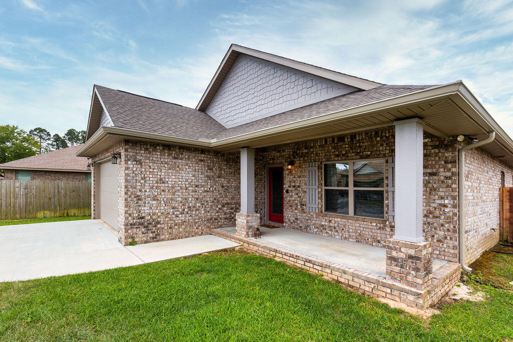 Welcome to 725 Upper Heron Way in Heron Bayou - a private, gated neighborhood directly off Hwy 98 with a community pool in a serene setting in Southwest Pensacola. This Craftsman style home is an absolute GEM, featuring 3 Bedrooms & 2 Bathrooms, a 2-Car Garage, and great outdoor spaces! Recently built in 2018, the home showcases quality architectural features throughout to include 10-ft trayed ceilings, crown molding, tall baseboards, cased windows, granite counters throughout, and solid wood cabinetry with dovetail construction and soft close drawers and doors. The absolutely stunning centerpiece of the home is a custom kitchen island that overlooks the Great Room. Sure to impress, this is the perfect gathering place for friends and family.