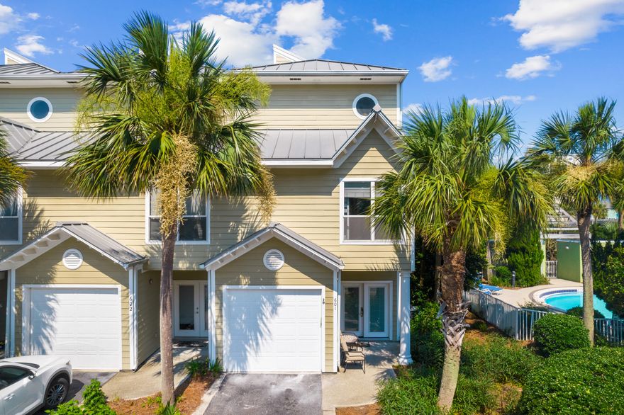 This three-bed, three-bath townhouse is steps from the beach and adjacent to the community pool. Where better for a primary/second home or vacation rental? There is parking for two vehicles in the driveway and offers tantalizing gulf views from the top-floor balcony. Offered fully furnished, this three-story unit has a surprisingly spacious interior with a bedroom and full bathroom on each floor for extra privacy. Freshly painted, it has new flooring and updated furnishings throughout. The first floor includes a garage, a front porch and a guest bedroom with bathroom. One floor up, there's a spacious living room and kitchen which has attractive wood-tile flooring. Sliding doors bathe the room with natural light and provide access to the spacious balcony.