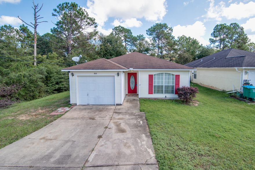 This lovely 3 bedroom, 2 bathroom home is MOVE IN READY! The appealing features outside include not only a one car garage, but an attached carport area big enough for two vehicles. Out back the wooded deck overlooks the nice partially wooded lot.Inside, attractive stylish tile flow through the flooring of the open concept living, dining, and kitchen space. The kitchen features granite countertops with plenty of surface, spacious white cabinetry and sleek stainless steel appliances.The split bedroom floor plans is perfect to fit the needs for a private master bedroom. The bedrooms are well appointed and offer plenty of light with padded wall to wall carpet. Both bathrooms have been updated with custom lighting, raised modern sinks and eco friendly toilets.