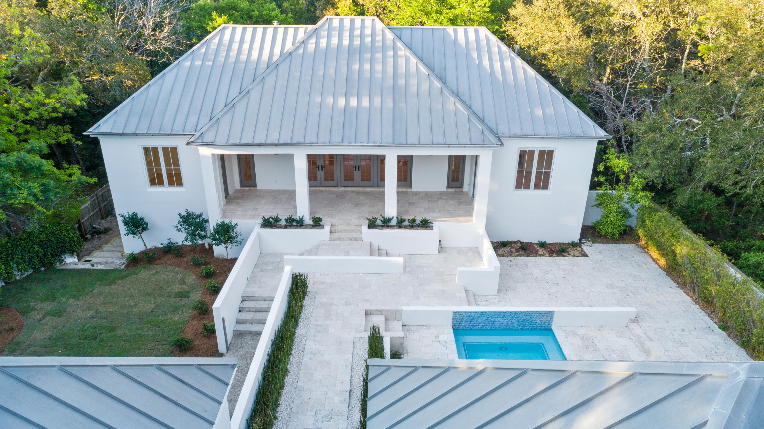 This gated estate is like none other offered in the community of Old Seagrove in Walton County. Sitting back from the street you will bask in the privacy and quiet upon entering your new hideaway located a short stroll away from the beach down Magnolia Grove. This quality constructed home is a fortress built of solid concrete block and has been fully renovated and professionally designed, with no details spared. Saunter under majestic oaks just a few blocks over to Seaside and Watercolor where you can enjoy shopping, dining, galleries, bars, concerts, and festivals. Or discreetly entertain to your heart's desire on the various decks, balconies, green space, or in the pool while enjoying the flickers of light coming from the gas lanterns on a breezy summer evening. This home is a beautiful