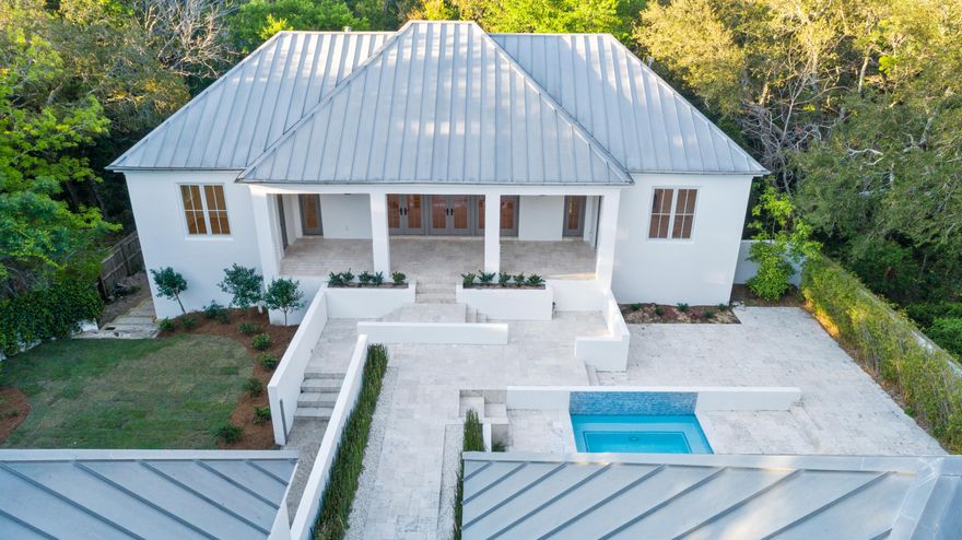 This gated estate is like none other offered in the community of Old Seagrove in Walton County. Sitting back from the street you will bask in the privacy and quiet upon entering your new hideaway located a short stroll away from the beach down Magnolia Grove. This quality constructed home is a fortress built of solid concrete block and has been fully renovated and professionally designed, with no details spared. Saunter under majestic oaks just a few blocks over to Seaside and Watercolor where you can enjoy shopping, dining, galleries, bars, concerts, and festivals. Or discreetly entertain to your heart's desire on the various decks, balconies, green space, or in the pool while enjoying the flickers of light coming from the gas lanterns on a breezy summer evening. This home is a beautiful