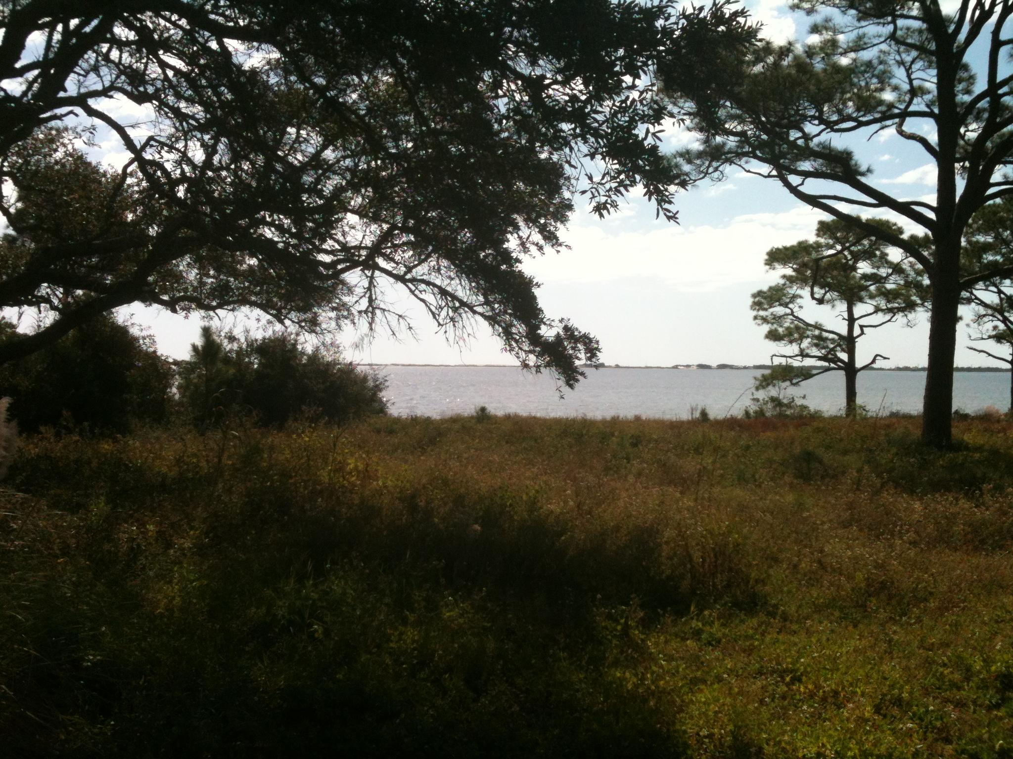 One of only 2 lots in a cozy subdivision minutes from Hurlburt Air Force Base. The lot has beautiful views of the Inter Coastal Water Way, and a two story house may offer views of the Gulf. There is a deeded access to the water where you could launch a canoe or a kayak. The property is on a cul-de-sac with public water and public sewer. The lot offers a mature oak tree which would adorn your backyard. All dimensions and legal to be verified.