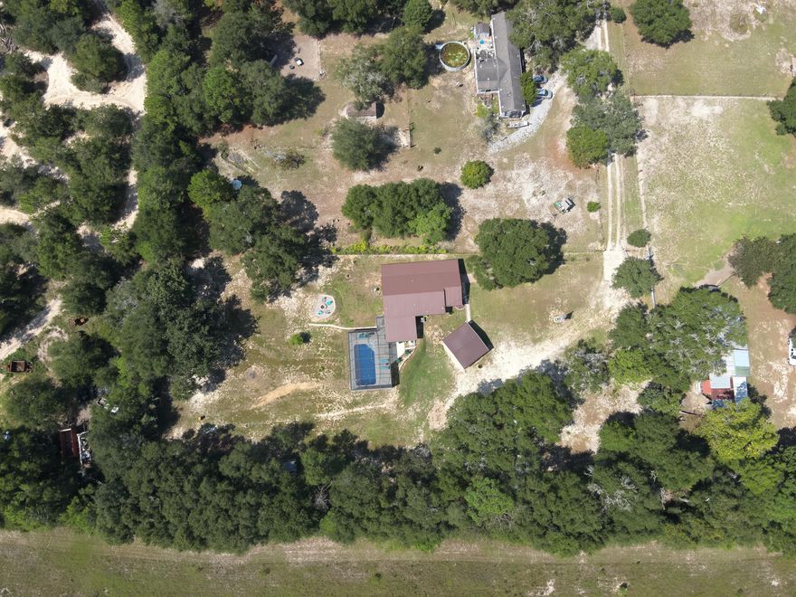 NO HOA! Country living at its best!  Completely remodeled 4 bed 2 bath home on 1.3 acres of very well-manicured yard! Enjoy the solitude of the country, while being only minutes from the town of Crestview and interstate 10.  Sellers have encountered all sorts of wildlife such as deer and rabbits while residing here. This house has been shown lots of love including a new 26-gauge metal roof with hurricane clips installed (11/2022). All new windows throughout the house (11/2022). Lennox air conditioner with whole house pure air purification system with a heat pump (10/2023). Saltwater pool, smart system, and ABS screened pool enclosure (11/2022). Seamless gutters with leaf guards (8/2022). Orkin Therm attic insulation (7/2023). And much more.