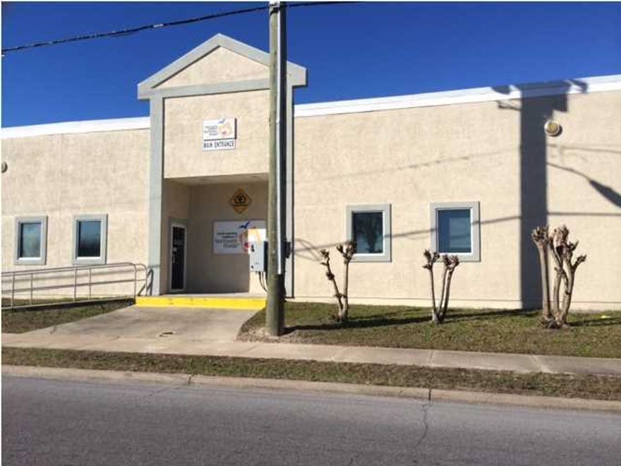 Large Box for office or can be built out for retail, located at a major intersection in Panama City Beach FL, 10,000 sf large parking area, great visibility, many different uses for this space.