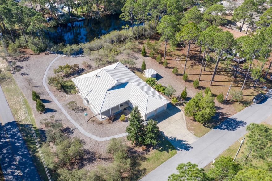 The highly sought after community of Santa Rosa Ridge, is located just off Scenic 30-A. Walking distance to the Emerald Waters of the Gulf of Mexico. This spacious home offers 4 Beds 3 1/2 baths sits on a corner lot that is almost a full acre. There is plenty of room to build that dream pool or a guest cottage. One of the first things you will notice when you walk in, is the superior quality craftsmanship. Built with steel framing, brick exterior and a metal roof. This home has a bonus A/C Storage room in attic, giving you plenty of storage. Wood deck on side of house leads to an inviting outdoor shower. Home is equipped with Hurricane shutters that are easy to install. Attached spacious 2 car garage. Santa Rosa Golf Course just a few blocks away. This home is a must see!
