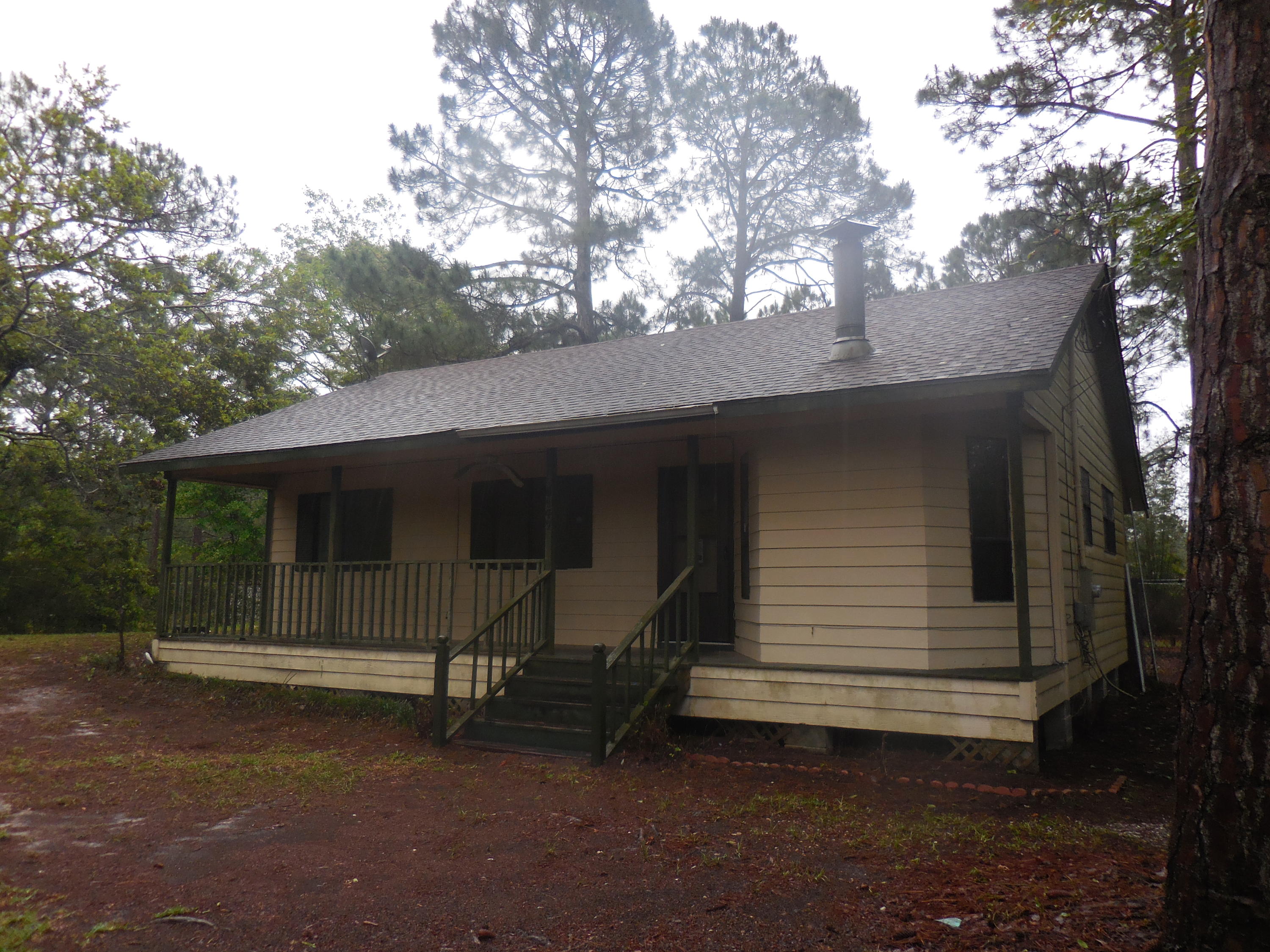 This is a Fannie Mae REO HomePath property. Great 2 bedroom home with the addition of a bonus room in the attic! The living room has a pot bellied stove in a bay window area, and the eat-in-kitchen is open through the passage wall/window between the two. The bathroom is even fitted for laundry facilities! This 0.46 acre lot is beautifully staged with gorgeous long leaf pines and sago palms. The full length front porch welcomes you, while the screened back porch is fantastic for those lazy summer night BBQs. The HVAC is missing.