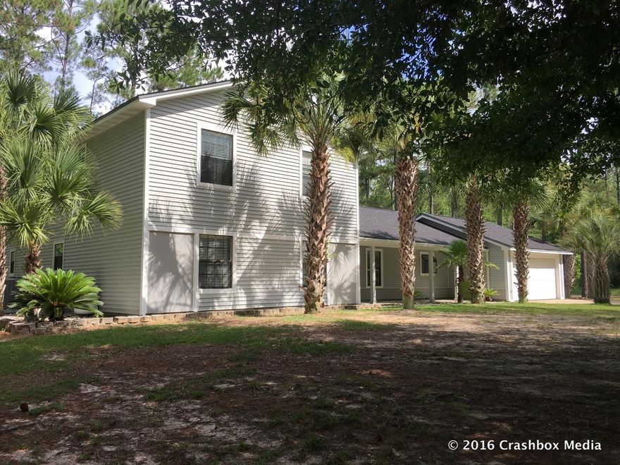 POSSIBLE OWNER FINANCING SUBJECT TO BUYER APPROVAL - Lovely home in Freeport sits on a corner lot. The home boasts a fireplace in the living room and master bedrooms, a renovated kitchen with Corian counters, oversized bedrooms, a two car garage, and more. The master suite boasts a wood burning fireplace, large walk-in closet, and private balcony. The property has an enclosed in-ground pool with jacuzzi, lovely landscaping, detached garage (in addition to attached garage) with workshop, and a great location. This property truly offers the best of both world with a country setting close to growth and about 10-15 minutes to the beach. The home is being sold as is. All information is approximate and should be verified.