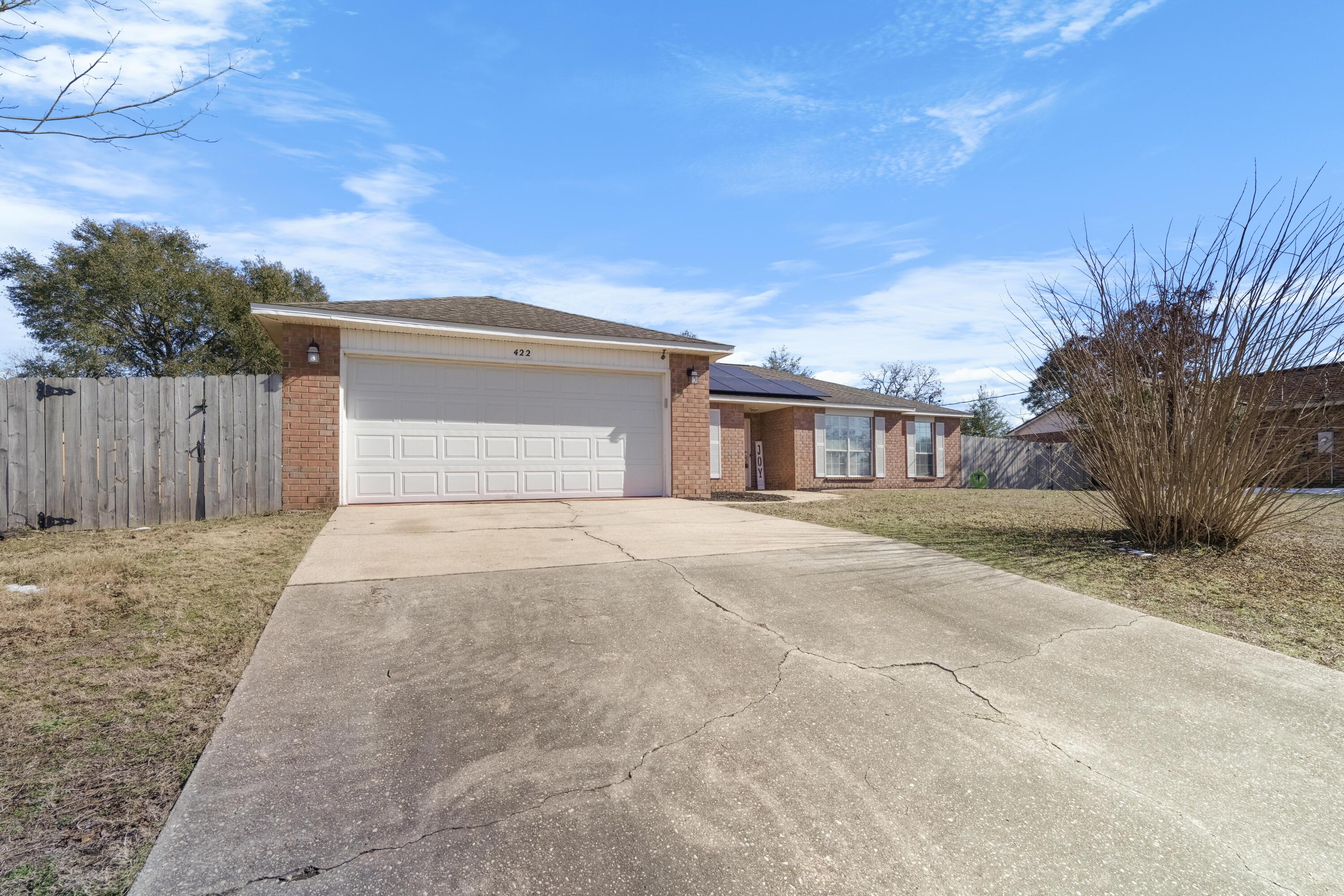 Welcome to this stunning, fully updated all-brick home in South Crestview! This spacious 4-bedroom, 2-bathroom gem also includes a charming bonus sunroom with rustic barn doors, a formal dining room, and nearly 2,400 square feet of living space. With a flat, fully fenced backyard, this home offers both beauty and practicality. Enjoy peace of mind with a dimensional shingle roof replaced in 2016 and a brand-new HVAC system installed in 2023.As you step inside, you'll immediately notice the updated flooring and open-concept, split floor plan. The expansive living room features a cozy fireplace, perfect for relaxing or entertaining. The kitchen is a chef's dream with updated granite countertops, modern lighting, sleek stainless steel appliances, and a spacious eat-in area