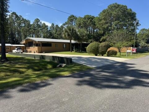 A MUST-SEE! 1.4 mi to Hogtown Bayou Park, 1.5 mi to Choctawhatchee Bay, 4.3 mi to Gulf! Do not miss out on this gem because it is a triple wide mobile home! Situated on over a half-care lot, is this inviting and spacious 2,244 square foot professionally stucco-clad home with many architectural features, upgrades & storage! Nestled on a cul-de-sac street in the quiet Camille Estates subdivision this property offers the perfect blend of comfort, style, and functionality for families, professionals, and anyone seeking a peaceful retreat near the Bay & Emerald Coast.From the large screened in front porch, step inside to the welcoming living room and discover a fluid, thoughtfully designed floor plan. The home features three comfortable bedrooms and two full baths, providing ample space for daily living and guests. The great room - featuring a realwood-burning fireplace - serves as the heart of the home, perfect for relaxing or gathering with loved ones. A separate dining/bonus room off the kitchen offers flexibility as a playroom, office, or hobby space.
The large country kitchen is a chef's dream featuring an island & plenty of room for meal preparation, storage, and casual family dining. A wall of custom drawers and shelves add convenience and a touch of charm to the adjoining laundry room, making organization effortless.
The master suite is a private sanctuary with thoughtful custom touches throughout. Enjoy a built-in decorative chest of drawers for clothing & accessories in addition to inset shelves designed to accommodate the large flat screen TV & components (included!). The master bathroom is fully tiled with a multi-head shower and features custom built-in cabinets for storage and style. A spacious walk-in closet with more custom shelving completes this luxurious suite, providing abundant space for clothing and accessories.
This home showcases numerous finishing touches, from custom cabinetry, surround-sound speakers & components (included!) to unique built-ins. 2nd * 3rdl bedroom walk-in closets add storage and convenience for family members or guests. The home's layout and finishes are designed to maximize both beauty and functionality.
A small bathroom added to the office/man-cave/den 2 bonus rooms would easily turn this space into a mother-in-law suite! The 11'15' storage room inside the garage offers more than enough shelving and storage space for a monster tool, hobby and/or gadget collection.
1.4 mi to Hogtown Bayou Park with docks, boat launches & picnic area!!
1.5 mi to boat launch on Choctawhatchee Bay!
4.3 mi to Gulf of America at Ed Walline Beach Access!