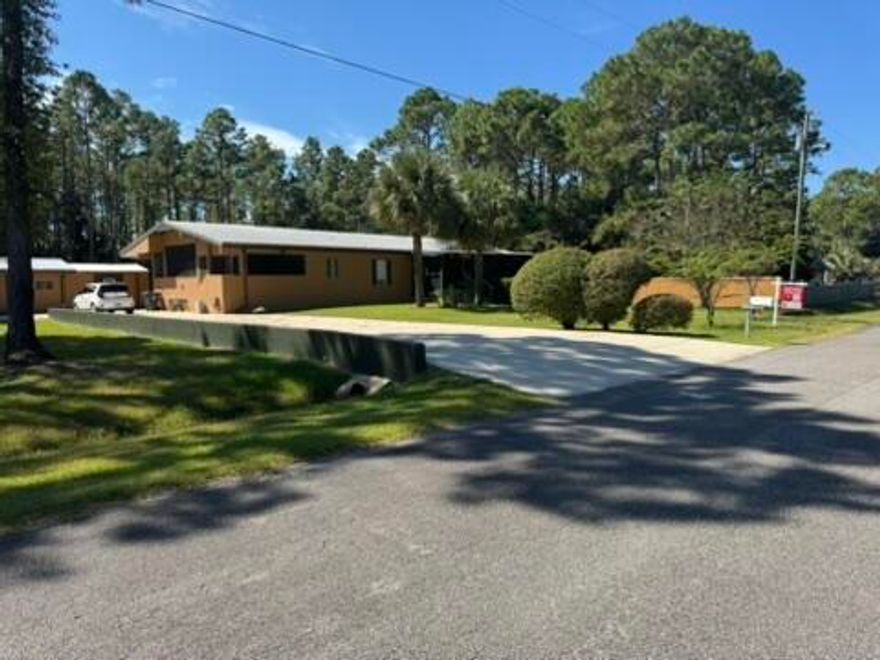 A MUST-SEE! 1.4 mi to Hogtown Bayou Park, 1.5 mi to Choctawhatchee Bay, 4.3 mi to Gulf! Do not miss out on this gem because it is a triple wide mobile home!  Situated on over a half-care lot, is this inviting and spacious 2,244 square foot professionally stucco-clad home with many architectural features, upgrades & storage!  Nestled on a cul-de-sac street in the quiet Camille Estates subdivision this property offers the perfect blend of comfort, style, and functionality for families, professionals, and anyone seeking a peaceful retreat near the Bay & Emerald Coast.From the large screened in front porch, step inside to the welcoming living room and discover a fluid, thoughtfully designed floor plan. The home features three comfortable bedrooms and two full baths, providing ample space for daily living and guests. The great room - featuring a realwood-burning fireplace -  serves as the heart of the home, perfect for relaxing or gathering with loved ones. A separate dining/bonus room off the kitchen offers flexibility as a playroom, office, or hobby space.
The large country kitchen is a chef's dream featuring an island & plenty of room for meal preparation, storage, and casual family dining. A wall of custom drawers and shelves add convenience and a touch of charm to the adjoining laundry room, making organization effortless.
The master suite is a private sanctuary with thoughtful custom touches throughout. Enjoy a built-in decorative chest of drawers for clothing & accessories in addition to inset shelves designed to accommodate the large flat screen TV & components (included!). The master bathroom is fully tiled with a multi-head shower and features custom built-in cabinets for storage and style. A spacious walk-in closet with more custom shelving completes this luxurious suite, providing abundant space for clothing and accessories.
This home showcases numerous finishing touches, from custom cabinetry, surround-sound speakers & components (included!) to unique built-ins. 2nd * 3rdl bedroom walk-in closets add storage and convenience for family members or guests. The home's layout and finishes are designed to maximize both beauty and functionality.

A small bathroom added to the office/man-cave/den 2 bonus rooms would easily turn this space into a mother-in-law suite!  The 11'15' storage room inside the garage offers more than enough shelving and storage space for a monster tool, hobby and/or gadget collection.

1.4 mi to Hogtown Bayou Park with docks, boat launches & picnic area!!
1.5 mi to boat launch on Choctawhatchee Bay!
4.3 mi to Gulf of America at Ed Walline Beach Access!


