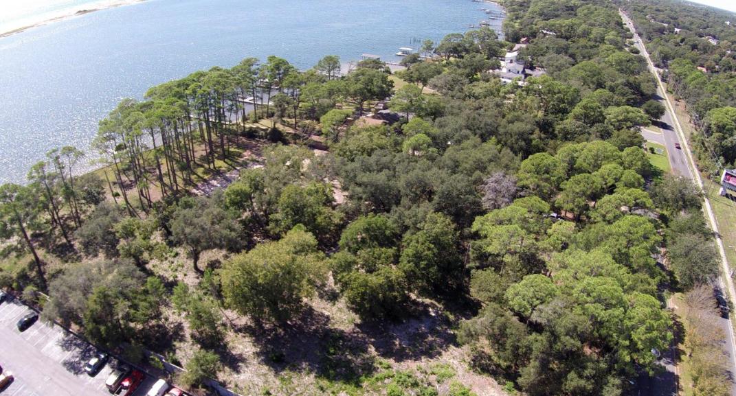 Coveted 3.18 acres of prime commercial land on Hwy 98 and the Sound. Rare opportunity to purchase property that has remained in the same family for generations and has been recently cleared with the removal of an old house. Scenic location is flanked by 314' water frontage and 250' of frontage on Hwy 98. The property is currently listed in Okaloosa County (but not within city limits) and can also be annexed into the City of Fort Walton Beach. County zoning is high density residential for up to 81 units and future land development is urban mixed use with the possibility of dividing. Motivated sellers and an ideal location will guarantee numerous inquiries and offers, so contact us immediately for more details.2nd parcel id# Any elevation above two stories will enjoy sweeping gulf vie