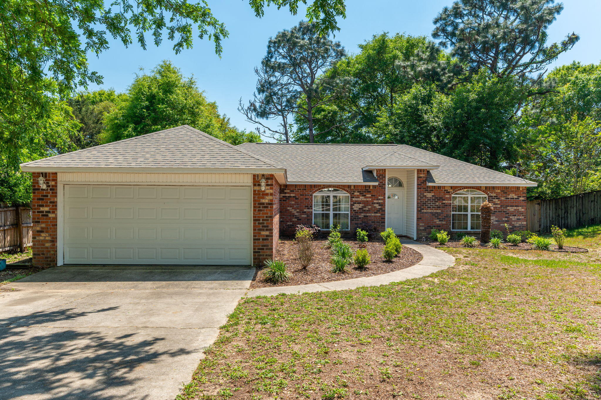Welcome to this beautifully maintained home in the desirable South Crestview area! Nestled among mature shade trees, this property offers exceptional curb appeal with a beautifully landscaped front yard and two striking arched windows that give the home a warm and elegant touch. Step inside and enjoy the spacious split-bedroom floor plan, designed for both privacy and functionality. The large living room features elegant tray ceilings, a cozy wood-burning fireplace, and serene views of the spacious, tree-lined backyard--perfect for relaxing or entertaining. The heart of the home is the updated kitchen, complete with refaced cabinets, granite countertops, a brand-new dishwasher, a pantry, and ample cabinet and countertop space. SEE MORE... The adjacent dining area is filled with natural light thanks to a large arched window overlooking the picturesque front yard. Retreat to the generously sized master suite, which includes a walk-in closet and a convenient vanity/sink combo. The additional bedrooms are located on the opposite side of the home, offering a quiet escape for family or guests. Enjoy the outdoors in the expansive backyard, featuring a large open patio ideal for grilling and entertaining under the shade of mature trees.
Major updates include: Roof replaced in 2022, Water heater replaced in 2023, New flooring, fresh paint, refaced kitchen cabinets, and granite countertops all completed in 2023
This move-in-ready home blends comfort, charm, and peace of mind with its thoughtful layout and modern updates. Don't miss your opportunity to make it yours!