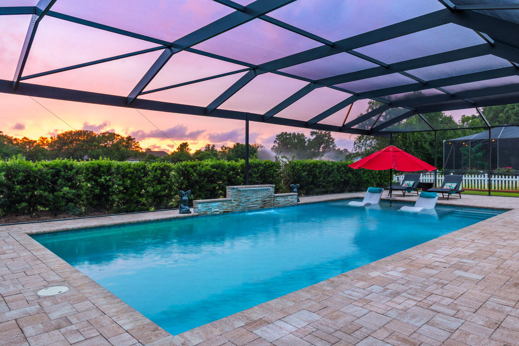 Luxurious Blue Haven Saltwater Gunite Pool home in Hidden Creek Estates! Experience resort-style living in this stunning custom home, perfectly positioned on the 5th hole double fairway of the prestigious Hidden Creek Golf Course. Enjoy captivating sunset views from your oversized lanai, featuring Panoramic Breeze panels for seamless, uninterrupted vistas. 30 x 16 pool boasts a slate stone fountain and upgraded tanning ledge, ideal for entertaining or relaxing in elegance. 200 sq ft Screened Lanai (60 x 30) for years of entertaining friends and family; Pool fully integrated with a Hayward ProLogic system and Wifi to control; Inside, a thoughtfully designed open concept layout, where elegant entry flows into a formal dining area and light filled living room with striking stone slate gas fireplace overlooking stunning pool, Oversized Lanai, AND golf course! LVP throughout home except bedrooms; French Doors lead to large office/media room; The designer kitchen is a chef's dream, equipped with Cavalier cabinetry; granite countertops, stainless steel appliances, as well as gas service to the stove; Kitchen has under cabinet and over cabinet lighting for ambiance, soft close drawers; Microwave vents to outside; Coffee bar for starting the morning organized, refreshed and ready for the day! The stone slate gas fireplace adds warmth and charm to the main living area with views to the gorgeous pool, lanai, and Golf Course! Master Bedroom is separate from the additional bedrooms and office for privacy and overlooks the golf course, with a door to the pool area; Newly remodeled Tiled Shower with gorgeous accents! The Master Bedroom Trey Ceilings show impeccable taste as well as recessed lighting; Master Bath is tiled with double vanities, separated and spacious, with private water closet; Additional large bedrooms offer full large closets, with granite in the full baths; Inviting front porch has slate stone columns and home has sprinkler system; With underground utilities, timeless finishes such as Bullnose corners, and a layout designed for both comfort and luxury, this home truly stands above the rest in Hidden Creek. Recap: 30 x 16 slate fountain POOL with tanning ledge and built in lounge chairs! Don't miss your chance to own this exceptional golf course retreat where elegance meets everyday functionality. Luxurious unparalleled coastal beauty awaits you! Hidden Creek Estates on the 5th Fairway! 0.3 Acre! The Club at Hidden Creek received a 4 star rating from Golf Digest's 2006/2007 ''Best Places You Can Play'', one of only 5 courses in the Panhandle to receive this award. Hidden Creek Estates is only minutes to the pristine white sugar sand beaches and emerald water of the Gulf of America. Ownership includes membership to Holley by the Sea's multi-million dollar 45 acre recreational center with 8 clay tennis courts, 3 swimming pools, full gym, aerobics, summer camp, lighted basketball courts, sauna & steam room, playground game room, community house on Santa Rosa Sound with playground, dock, access to the East Bay boat launch and many community events.