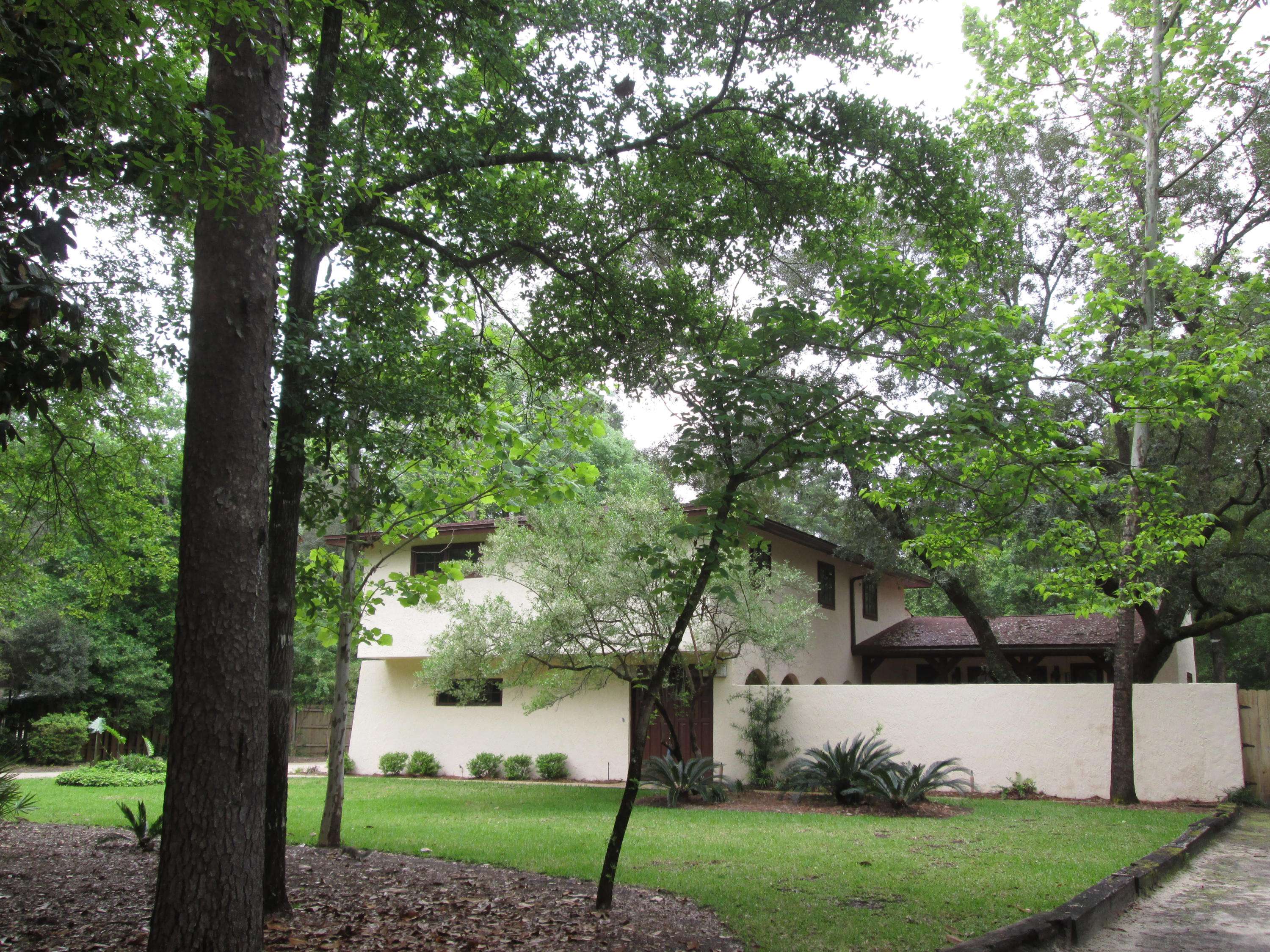 Custom designed home in the beautiful neighborhood of Rocky Bayou. This awesome lot, which is over 1/2 acre has mature trees, privacy fenced backyard, storage area for boat or RV and the complete privacy allows for many other options. Wonderful 20 X 40 inground pool with an outside shower, separate yard building, side courtyard with gas grill, covered patio and an entryway into a small study / office. Front entryway is hidden behind a privacy gate/wall that leads into a courtyard. There are 2 entryways into the home from the 19' X 16' courtyard which you will enter like a tri-level and brings you up into a spacious family room with a wood burning fireplace, built in shelves and 2 sets of double doors, one which leads out to the backyard and pool, the other to a cozy area in the courtyard