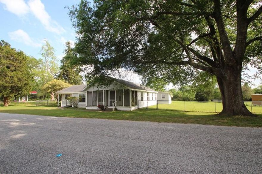 Cutest cottage on a nice sized lot in the center of Laurel Hill. Home is being sold ''as is'' but appears to be livable and just needs some updating. There are two bedrooms but there are a couple of other rooms that could serve as bedrooms but can't be listed as such since they have no closet. Nice sized living room and dining room. Good sized den with separate entrances both front and back. Large shop in the backyard. Screened front porch. Home appears to have central air and heat but it also has gas space heaters, gas hwh, and a gas range. There is no propane tank at this time so potential buyers would have to install their own for inspections. Great price. This would make a nice rental or residence and, at this price, you could do a little fixing up!This property is eligible