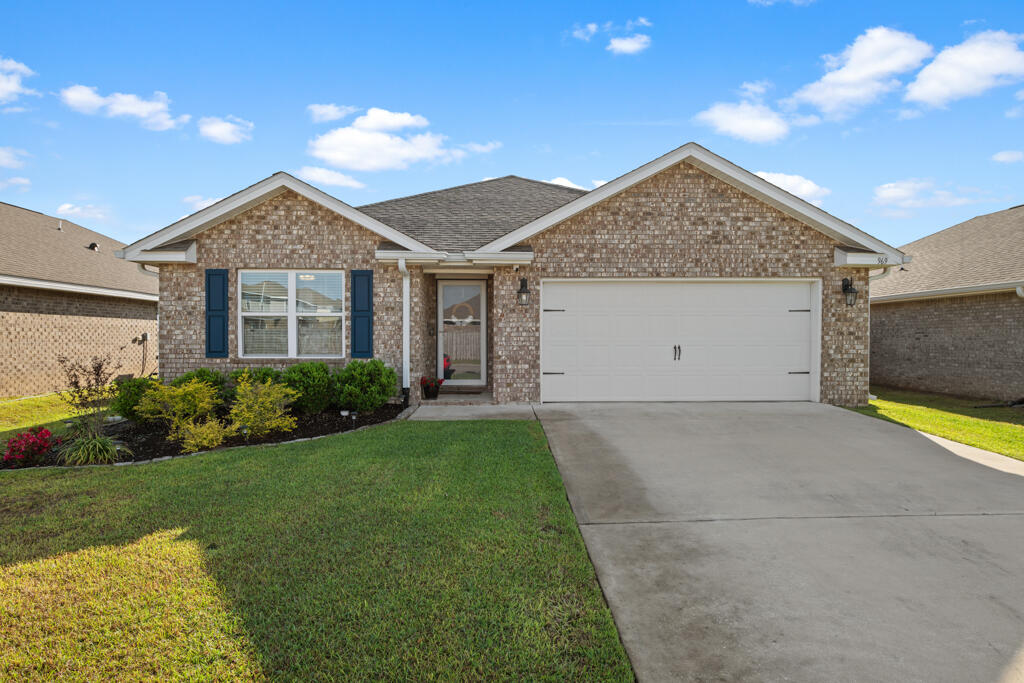 Welcome to Redstone Commons in Crestview, Florida--a master-planned community ideally located next to both Riverside Elementary and Shoal River Middle School. This vibrant neighborhood features top-tier amenities, including a resort-style pool, clubhouse, dog park, and playground.This well-maintained 4-bedroom, 2-bathroom home offers 1,852 square feet and a desirable split-bedroom floor plan. Step inside to find engineered vinyl plank flooring and a charming board and batten accent wall, beautifully complemented by soft grey walls.To the left, two bedrooms are separated by a full guest bathroom, while a fourth bedroom on the opposite side serves perfectly as a home office. The heart of the home boasts an open-concept layout, with the kitchen overlooking the dining area and living room.

The kitchen is appointed with granite countertops, a spacious island, white cabinetry, and a brand-new white subway tile backsplash. Off the living room, the primary suite easily accommodates a king-size bed and features a large window letting in plenty of natural light. The ensuite bath includes a double vanity, walk-in shower, and ample closet space.

Out back, enjoy a covered patio that opens to a fenced backyard with no rear neighbors. The home backs up to a community water retention area, offering lasting privacy and no future construction behind you.

The two-car garage has been freshly painted in a medium grey and features a durable epoxy-coated floor, giving it a clean, finished look that's both functional and stylish.

This home combines comfort, style, and locationready for you to move in and enjoy!