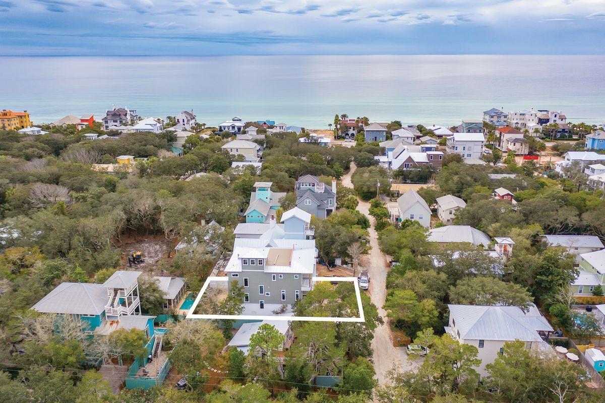 Situated in the heart of Old Seagrove West of County Road 395, this exemplary new construction is characterized by ample open living space including a sprawling fourth story rooftop deck as well as panoramic views with corridors of the gulf of mexico and seaside town. Located only a few blocks from Seaside, FL, this six bedroom (plus two bunk spaces), eight bath home features an impressive three story vertical footprint with open living space and resort style amenities including an oversized heated pool with adjoining spa surrounded by a lush, private outdoor living area.