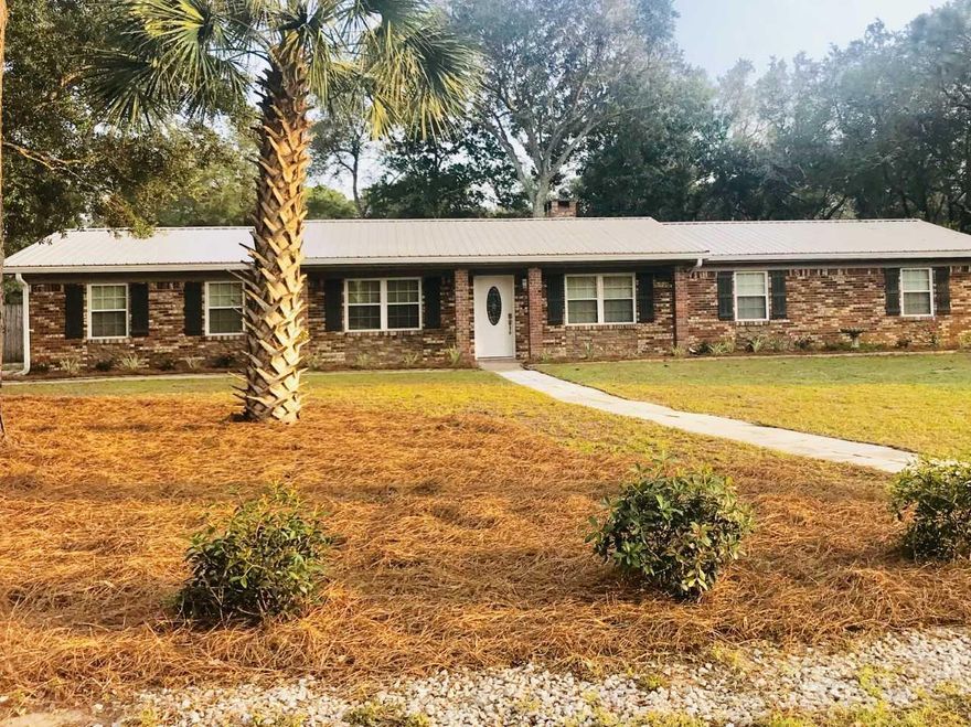 Make yourself comfortable in this move in ready, completely remodeled home. Let's begin with the 50 year metal roof, tankless hot water heater, brand new stainless steel appliances in kitchen plus Samsung front load washer and dryer. You will walk into one of the family rooms with a wood burning fireplace. Then you will enter the kitchen with new granite which opens up into the second family room. Bedrooms are down the hall with brand new carpet. You will find tile wood look flooring in the other rooms. Both bathrooms have been remodeled with intricate tile work. You also have a brand new Florida room that is heated and cooled off the kitchen. Back yard is big enough for a pool with a play set and 2 sheds. Check out the beautiful landscaped front yard. You don't want to miss it!