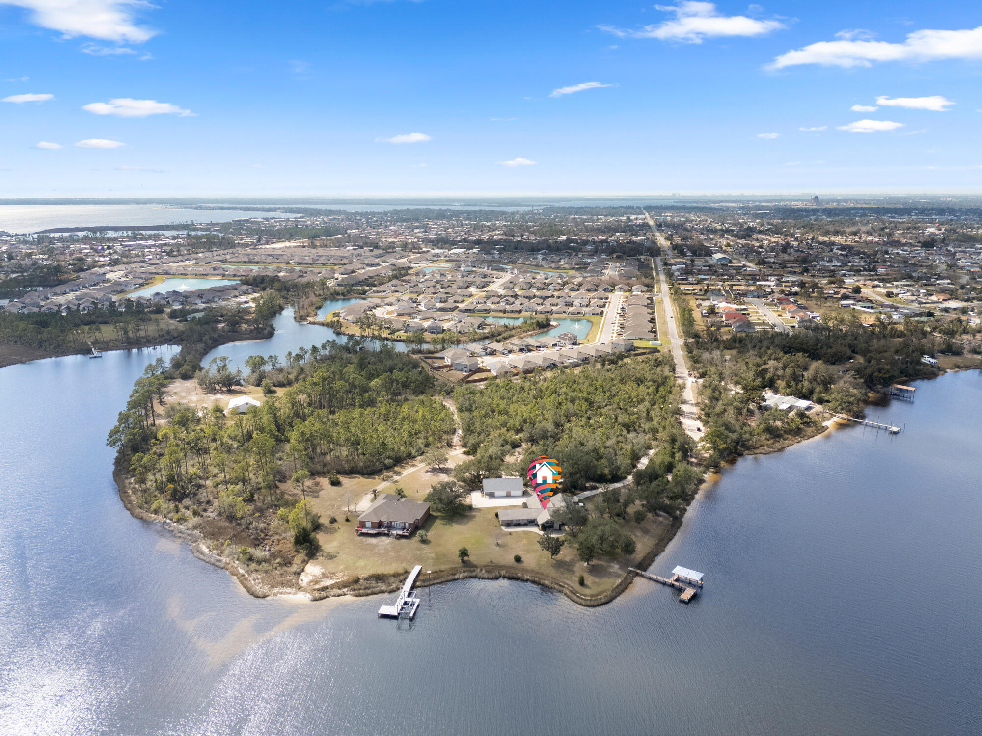 7300 Boat Race Road. This stunning 10+ acre waterfront property in Bay County, includes over 900 feet of frontage on Callaway Bayou. With easy and direct access to East Bay, St. Andrews Bay, and the Gulf of America, this prized location sits on a point, offering unmatched panoramic views of the water and surrounding wildlife habitat. The home combines luxury and functionality. The gourmet kitchen features a custom breakfast bar, two dishwashers, a built-in ice maker, separate below counter freezer drawers, a Sub-Zero refrigerator, a five-burner propane gas cooktop, a vented range hood, a warming drawer, and a convection microwave oven. Vaulted ceilings with exposed wood beams enhance the open floor plan of the main living areas. Crown moulding throughout the home highlights the attention to details. With its own unobstructed view of the Bayou, the master suite includes a large walk-in closet, a separate cedar-lined closet, and also a private office. The spacious en-suite bath includes a walk-in shower, a separate jetted garden tub, double vanity, and a bidet. The guest wing of the house includes a large bedroom, full bathroom with a walk-in shower, a dining/living area with a wet bar. Separated from the main house by a pocket door, the guest wing has three external entry ways: a main door with foyer, access to a private patio from the bedroom, and access to the Bayou from the living room. Additional highlights include a whole house standby propane generator package, a central vacuum system, two geothermal HVAC systems, and two electric water heaters, and low-profile retractable hurricane shutters. The exterior of the property is equally impressive, featuring a boat dock with a covered slip and boat lift. There is an attached garage as well as a 2-car detached garage with an exercise room, and a spacious loft area, ideal for storage or future expansion. This waterfront-front property is a unique and extraordinary Estate.