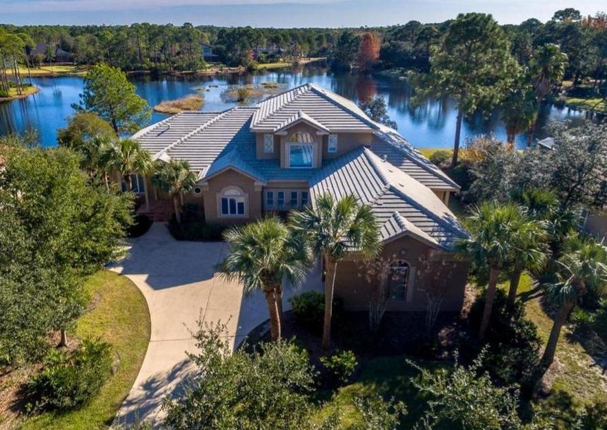 This gorgeous 5BR/4.5BA, 5,103SF lakefront home has beautiful views from almost every room. As you enter the home you are greeted by soaring ceilings and an open living area with great room, living area with fireplace, kitchen, & formal dining room. The master suite is on the 1st floor and features tray ceiling, lanai & pool access, duel vanities, walk-in closet, large jetted tub, & separate shower. There is also a mother-in-law suite with private kitchen & living area with fireplace & pool access. Upstairs there are 2 bedrooms with a large adjoining playroom and Jack & Jill bath. Other features include IFC conduction, an additional bedroom with private bath, oversized 3 car garage, heated pool, and 125FT on the lake. Too many features to list, a must see!