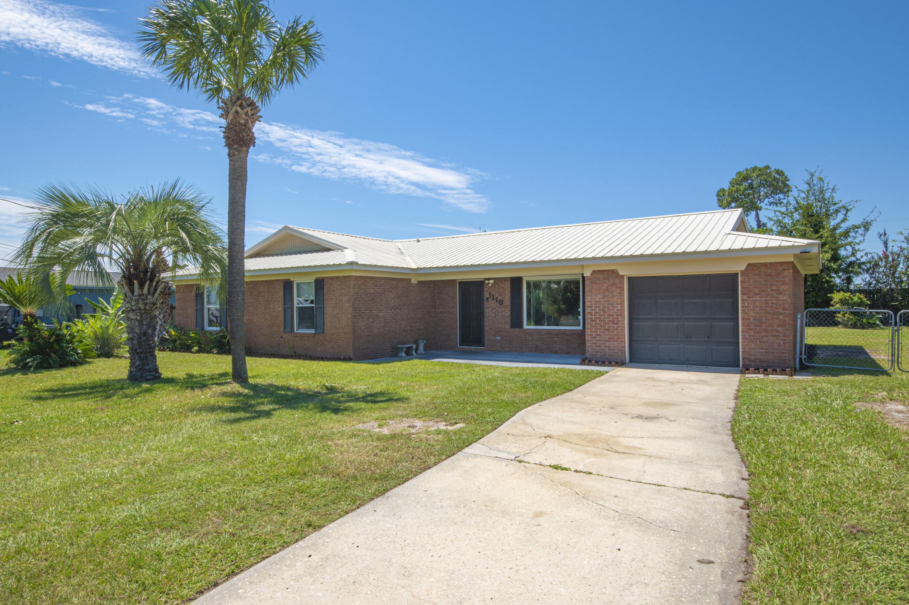 Welcome to your perfect family home, nestled in a vibrant community, close to the conveniences of everyday life. This delightful three-bedroom, two-bathroom brick ranch offers a blend of modern updates and timeless appeal, ensuring a comfortable lifestyle for you and your loved ones. Upon entering, you are greeted by a warm and inviting family room. This spacious area serves as the heart of the home, complete with a cozy fireplace that adds charm and warmth to those cooler evenings. The open layout makes it an excellent space for family gatherings or quiet nights in. Adjacent to the family room, you'll find an updated kitchen designed for both function and style. Modern fixtures, ample cabinetry, and sleek countertops provide the perfect setup for preparing meals and entertaining guests. Whether you're a seasoned cook or a casual meal preparer, this kitchen will meet your every need with ease. The master bedroom is a true retreat, featuring ample space to unwind after a long day. It includes a private master bath, giving you a personal sanctuary right at home. Each additional bedroom is generously proportioned, making them ideal for family members or guests. Step outside to discover a beautifully fenced backyard, an ideal space for children to play safely or for hosting family gatherings and barbecues. This outdoor area is both private and spacious, offering the perfect blend of relaxation and recreation. Location is paramount, and this property truly shines in its proximity to local amenities. A short distance away, you'll find Tyndall Airforce Base and an array of restaurants, making dining out a breeze. Shopping centers are conveniently nearby, providing every retail option you could desire. For families, local schools and parks are within easy reach, facilitating both education and outdoor activities for children. This property is not just a house; it's a place to call home. It offers a thoughtfully designed living space in a thriving community, perfect for creating lasting memories. The combination of its cozy feel, updated amenities, and superb location meets all the needs of a modern family. This Home is a MUST SEE!!