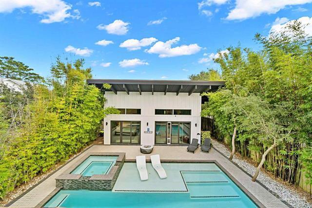 Located in the highly sought-after Seagrove Beach community with no HOA, 94 S Gulf Drive is an impeccably designed, custom-built modern masterpiece offering refined single-level living and total privacy. The chef's dream kitchen features a 12-foot island, Italian-made range & oven, butler's pantry, quartz countertops, and custom cabinetry. Light fills the open, airy floor plan with soaring ceilings and designer finishes. The primary suite delivers a spa experience with a 7-foot soaking tub and aromatherapy steam shower featuring eight shower heads and a rain feature. Every bath is fully tiled and wheelchair accessible. Outdoor living includes a screened-in porch, resort-style pool with 10-person hot tub, and gas fire pit, all within a completely private backyard sanctuary.