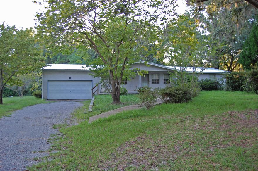 Great Location in the heart of Freeport. Home sits on a half acre lot and has another half acre lot next to it. Additional lot features a private well and the home is on city water. The home can use a little TLC and updating but is well built. The current owner has used the home for a rental property for the last 8 years and the carpet has been removed. The home has a two car garage, split floor plan and large laundry room. A new metal roof and hot water heater have been added within the last two years. The back yard is chain link fenced. There are a lot of possibilities with this home and property.