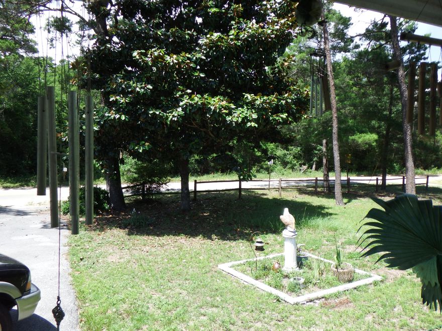 Large corner lot .6 miles from the bay. The large backyard is fenced with a utility shed. There is 16x14 Florida room added on to the home used for den or TV room. There is a 15x10 converted front porch with circular driveway. Home has two masterbedrooms' located at either end of the home. Home needs TLC.