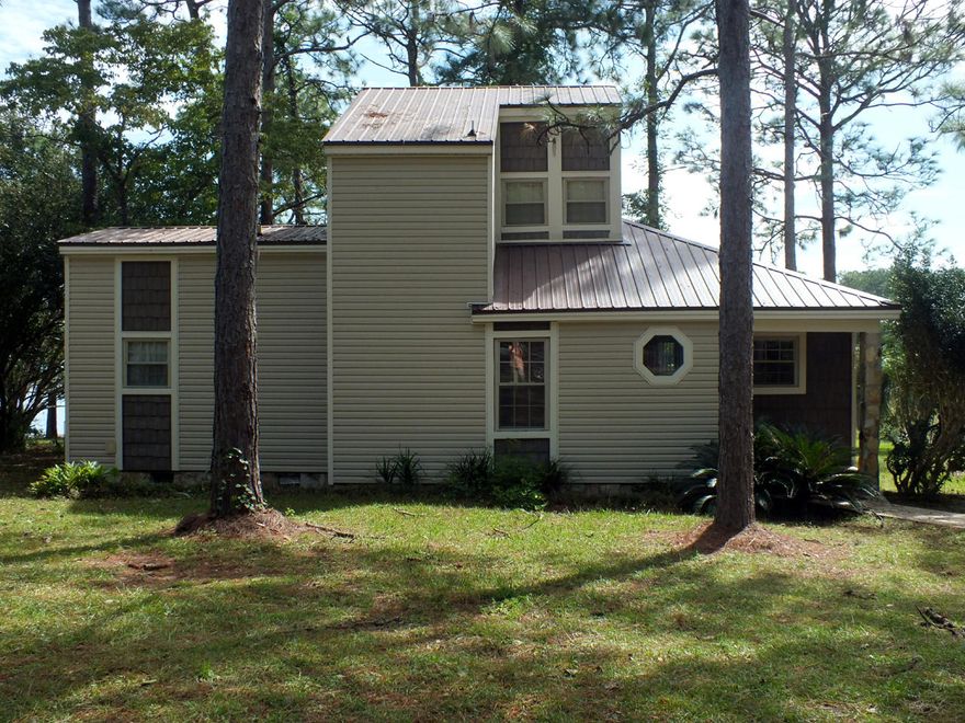 Beautiful waterfront home on Kings Lake, a 374 acre man-made lake 6 miles from historic DeFuniak Springs. The house features a large open living room with water views. The kitchen and dining area are off of the living room and provide access to a screened porch and large deck, both of which can also be accessed from outside. A small and a large bedroom share a bathroom. The laundry room completes the 1st floor. The 2nd floor consists of a large bedroom and bathroom and a balcony that provides lake views. The back yard contains numerous trees, plants and shrubs and gently slopes down to 102 ft of waterfront. The dock needs to be rebuilt. Defuniak Springs has been voted the best mall town in Florida by msn.com and is 45 minutes from the beaches, restaurants and shopping of South Walton.