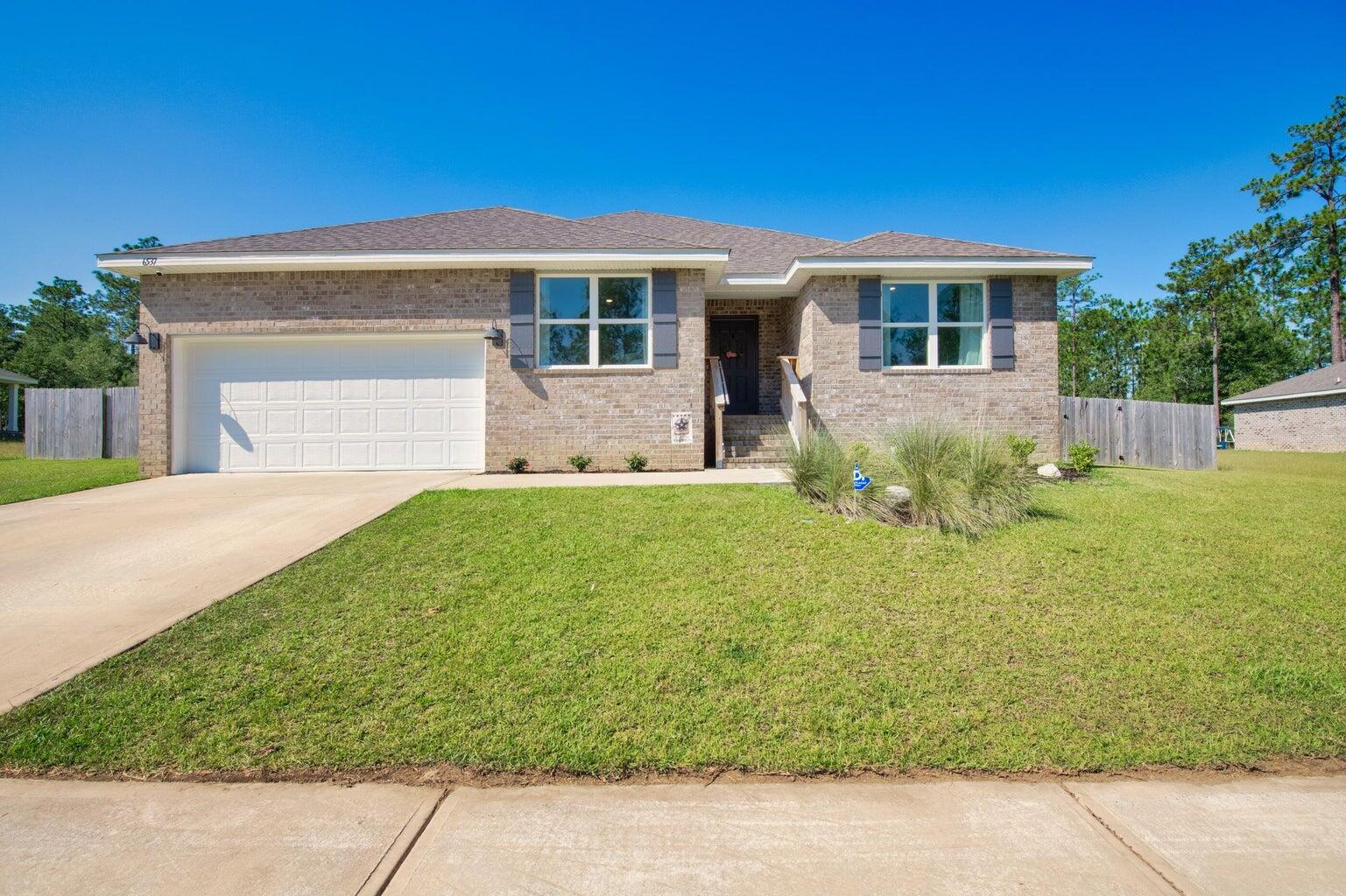 This spacious 5-bedroom, 3-bath home features an expansive open design, complemented by a covered patio and a 2-car garage. Throughout the home, enjoy wood-look flooring with plush carpeting in the bedrooms. The kitchen offers a large island bar, perfect for additional seating, along with a smooth top range, built-in microwave, stainless steel appliances, and a generous corner pantry. Adjacent to the kitchen, a cozy breakfast nook and separate dining area offer ample space for gatherings. The primary bedroom is accompanied by a stunning ensuite bathroom featuring a double vanity, large shower, and a spacious walk-in closet. No smoking allowing. Pets allowed pending owner approval and pet fee.