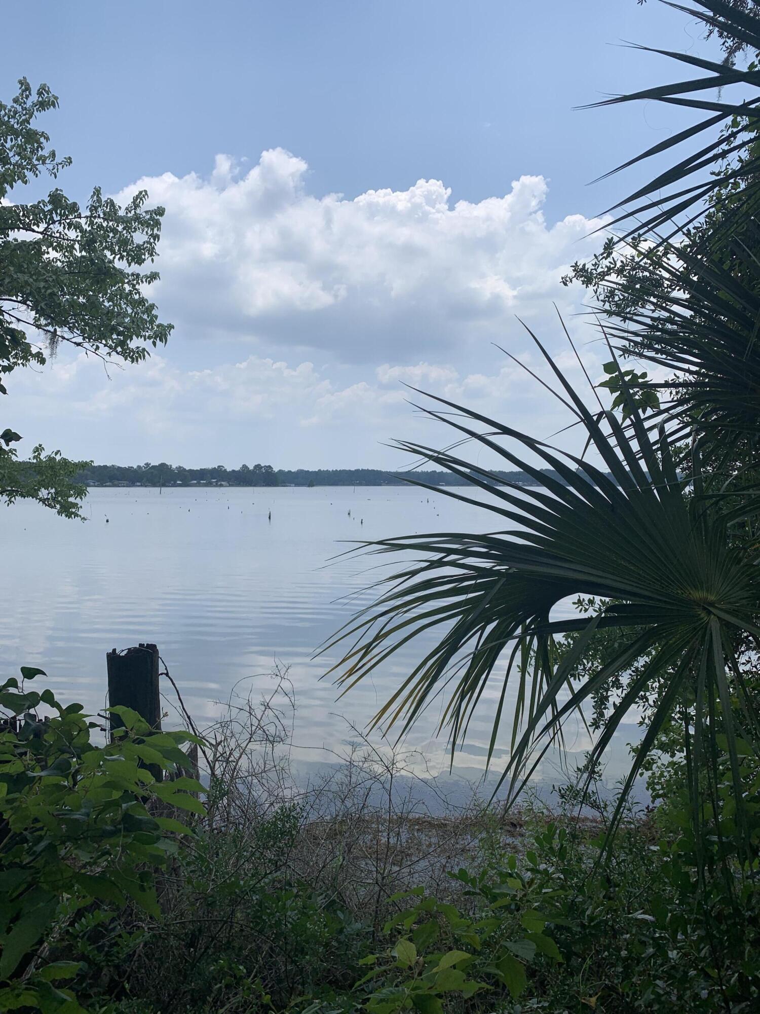 Don't miss this chance to snag a highly sought after water front lot on Juniper Lake! This stunning parcel of land boasts unobstructed views of the glistening Juniper A small weathered fishing cabin sits on the parcel close to the water's edge. The cabin is on a septic system and is fully wired.  This serene and peaceful location offers the perfect retreat for those seeking an escape from the hustle and bustle of city life. The lot is ideally situated for a variety of uses, including the construction of a private residence, vacation home, or rental property. The parcel offersaccess to a variety of outdoor activities, including snorkeling, kayaking, and fishing. Call for a private showing today!