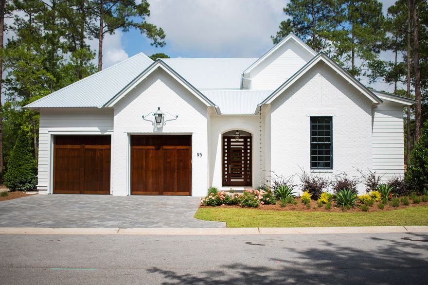 Newly completed within the gated Churchill Oaks neighborhood - This stunning Magnolia plan is designed by Savoie Architects and is situated on a beautiful spring-fed lake offering 4 bedrooms with the master on the main level, 4 and 1 half bathrooms, a 2-car garage with hardwood white oak floors, tongue-and-groove kitchen ceiling and Venetian plaster accent walls. The private courtyard with a pool, summer kitchen, loggia and lounge area offer endless summer fun without ever leaving home. The spacious first floor features an open living area centered around a modern ribbon fireplace and grand dining room with a full wet bar. The chef's kitchen overlooks the courtyard and dining area with beautiful quartz counters, slab cabinets, Thermador appliances + more high-end finishes.