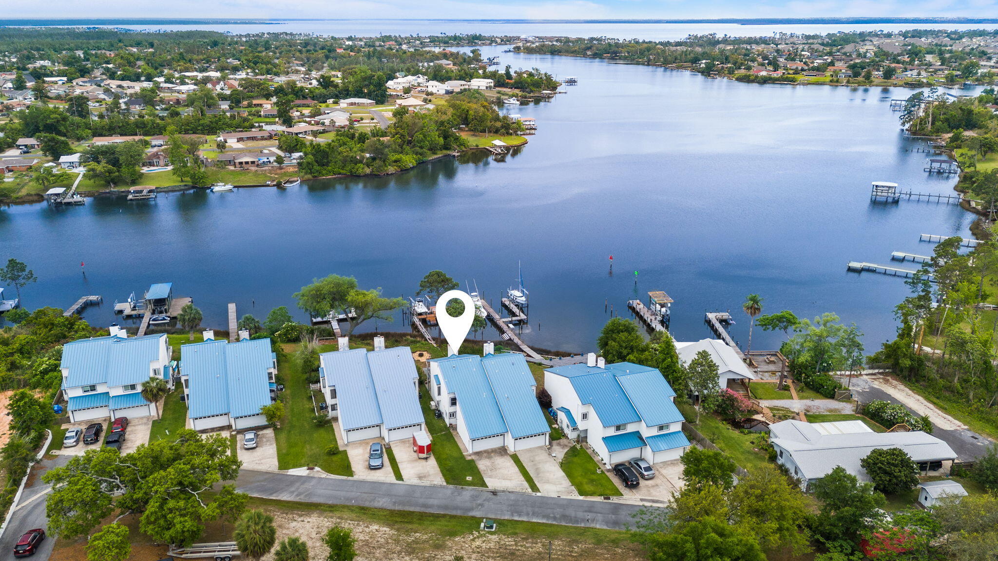 Live your best life in this WATERFRONT townhome located on the bayou in Panama City, Florida! This exquisite townhome offers a unique blend of comfort, style and enjoy the coveted waterfront lifestyle we love in Florida. Just under square feet, this townhome offers a great layout and breathtaking views with deep water access. Upon entering, you are greeted by newly painted interiors that are fresh and bright and flooded with natural light. The main level features an open concept great room, seamlessly integrating the living, dining, and kitchen areas. The kitchen offers custom cabinetry and a large island with ample seating. A large pantry is found under the stairs and a nook perfect for a coffee station or bar is found adjacent to the kitchen. A stone fireplace anchors the living room and and is surrounded with French doors to the covered patio where you'll enjoy every minute looking at the great views! A conveniently located powder room on this level ensures ease and comfort for guests, as well. This waterfront townhome offers three bedrooms and two and a half bathrooms.
The primary suite is a true retreat, offering ample space and privacy. It features double French doors that open to a covered porch, providing a private seating area overlooking the water. The additional bedrooms offer great size closets and share a bathroom accessed by the hall. One of the standout features of this townhome is its waterfront location, situated high upon a bluff overlooking the Bayou.
Residents can enjoy direct access to a dock, perfect for boating enthusiasts and those seeking to fish and enjoy the outdoors. With Shell Island just 15 minutes away, endless adventures await on the pristine waters of the Gulf of America. This home is also just 12 minutes from Tyndall Air Force Base making it a desirable location for those looking for a waterfront property at a great price! You're going to love living waterfront with little maintenance.
The outdoor living on this townhome is incredible and with covered porches on both levels, you'll love this setting for relaxation and entertainment. There is a built-in firepit in the backyard surrounded by landscaping and overlooking the dock further enhancing the great outdoor living amenities! Whether savoring morning coffee or hosting evening gatherings with family, these you'll enjoy views of the water and company.
The property includes a two-car garage, ensuring ample storage and convenience. This townhome is more than just a residence; it is an opportunity to embrace a waterfront lifestyle in one of Florida's most desirable locations. With its thoughtful design, premium amenities, and unparalleled access to the Gulf, this townhome is a great waterfront find.