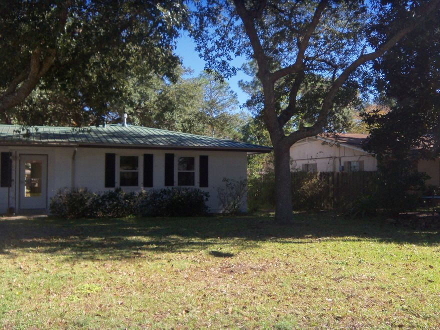 WOW,WOW and WOW. This home is move-in ready! Completely remodeled with NEW pergo laminate flooring throughout the living room, hall, & bedrooms. The kitchen & utility room are tiled. Fresh paint throughout the interior. The kitchen and baths have been upgraded with NEW cabinets, stainless steel microwave,dishwasher,refrigerator and smooth top stove appliances, light fixtures and plumbing fixtures. NEW HVAC system, NEW double pane windows. NEW metal roof. NEW French Doors w/ecased blinds leads to the spacious, fenced in, back yard. NEW DECK almost the length of the house. Lawn pump and sprinkler system.Sitting in the back yard is every man's dream. An oversized two car garage/workshop w/220 electricity. All shelving and cabinets convey. Owner has tagged the two that are not staying.