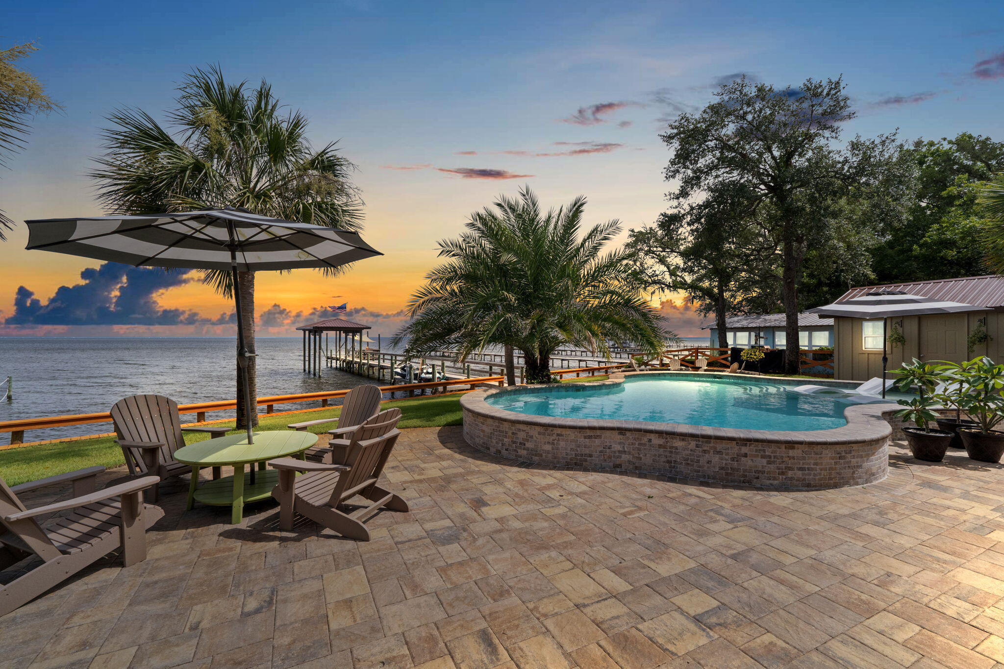 Step into the comfort of this well-positioned home in Gulf Breeze, located at 5938 E. Bay Blvd. This inviting 4 bedroom, 3 bonus room, 5-bathroom home boasts a generous layout including a large great room at the front and a cozy den with a fireplace at the back, perfect for relaxing while enjoying views of the Bay. The custom design was well thought out with details and precision during construction. The home is less than 4 years old and has over a half acre that is positioned to admire sunset views. There is 2 master ensuite rooms of your choice. One is on the first level off of the kitchen area and the other is upstairs for more privacy. The spa like bathrooms will have you feeling like you are on vacation for a lifetime.Half bath for the pool and outdoor guests and another