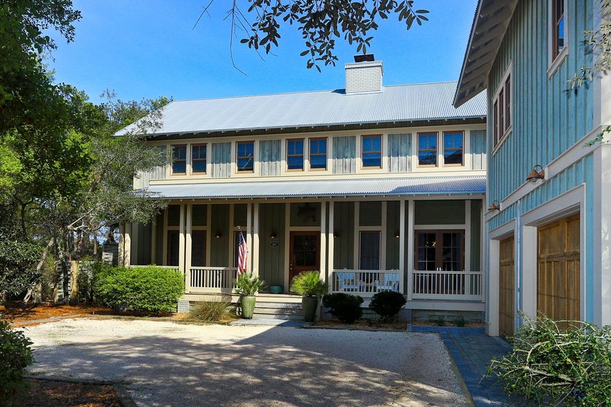 Mature wooded surroundings enhance the generous corner lot of this classic WaterColor home. Ideal as a vacation home or main residence, the family-sized accommodation is spread over two floors of the main house and a guest house located above the detached two-car garage. This self-contained annex has a bedroom, a double shower, fully-equipped corner kitchen and a separate dining area. A serene porch overlooks the activity below. Polished wood flooring extends throughout the residence, which has fourmore bedrooms with ensuite bathrooms and closet space. The master bedroom has the advantage of being on the first floor with a quiet sitting area and French doors onto the porch. The kitchen accommodates several creative cooks at once.