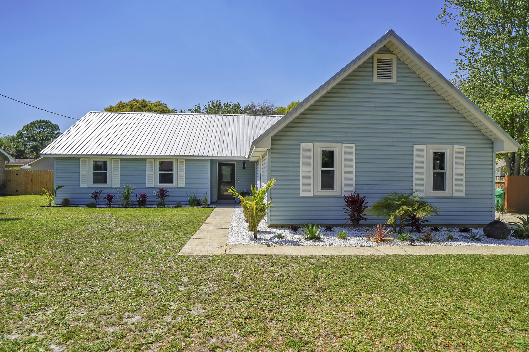 Gorgeous 3 bedroom 2 bath home in West Destin located within minutes of Harbor Walk Village, Crab Island and the beautiful beaches with no HOA. This house is also just a few blocks from Destin Elementary. Move-in ready and has been remodeled top to bottom, offering an open floorplan, a large kitchen, a screened in patio and a spacious backyard. The fenced backyard features a firepit, home garden and enough space to park a boat/trailer and still have room to build a pool. Home also features a two car garage with an extra 8x7 room for storage, new HVAC (2021), new impact glass windows with warranty (2022), and a metal roof!