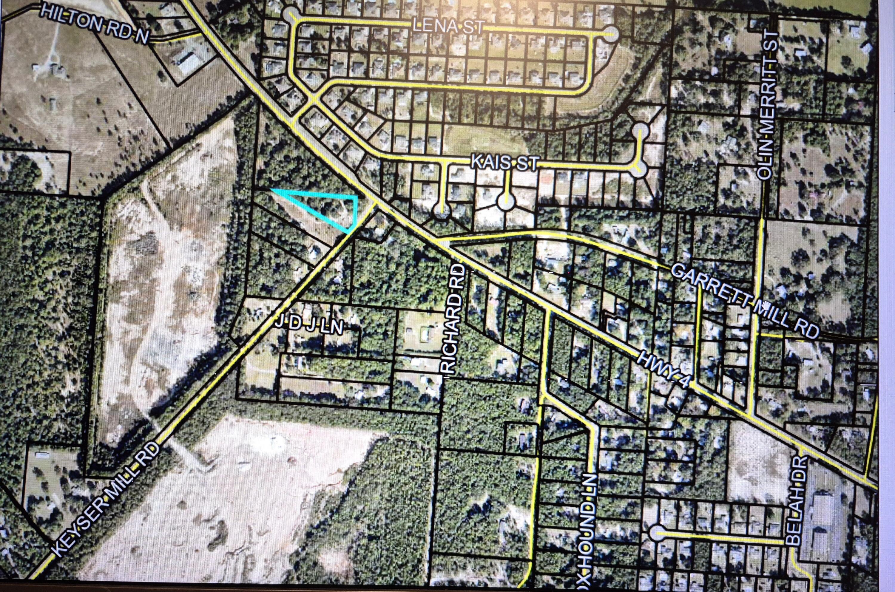 Only 200 ft to Hwy 4 in Baker, this lot has power pole, a pump shaft, and a septic tank (that are not warranted). Irregular lot is partially cleared as it was one homesteaded but now it is an empty lot waiting for you to build or just retain as an investment. Additional land available (1.98 acre adjacent). Bring us an offer!