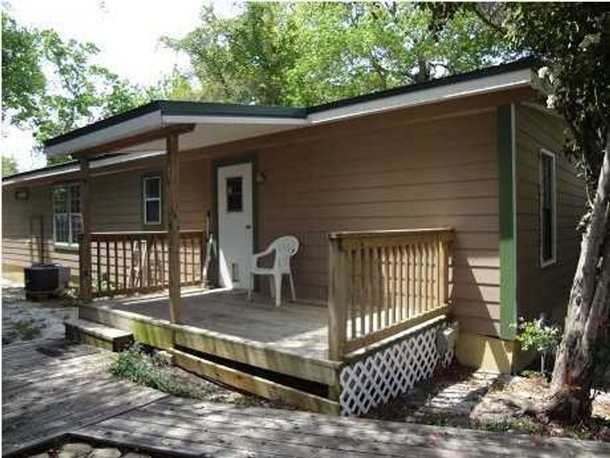 What a great location in Destin and for under $200,000. This 4 bedroom 2 full bath home with dining room has been well cared for and updated. Metal roof in 2011,  HVAC in 2012, hardy plank siding and porches have been added. This home has a large kitchen with a nice amount of  cabinets, a dining room that has been used as an office, and a laundry room. The laminate flooring makes it easy for cleaning. Enjoy the two porches and the private fenced-in yard. Wonderful for outdoor living.  A  storage shed in the backyard is included. This home is a short distance from the public boat launch at Joe's Bayou.  Selling 'As Is'.