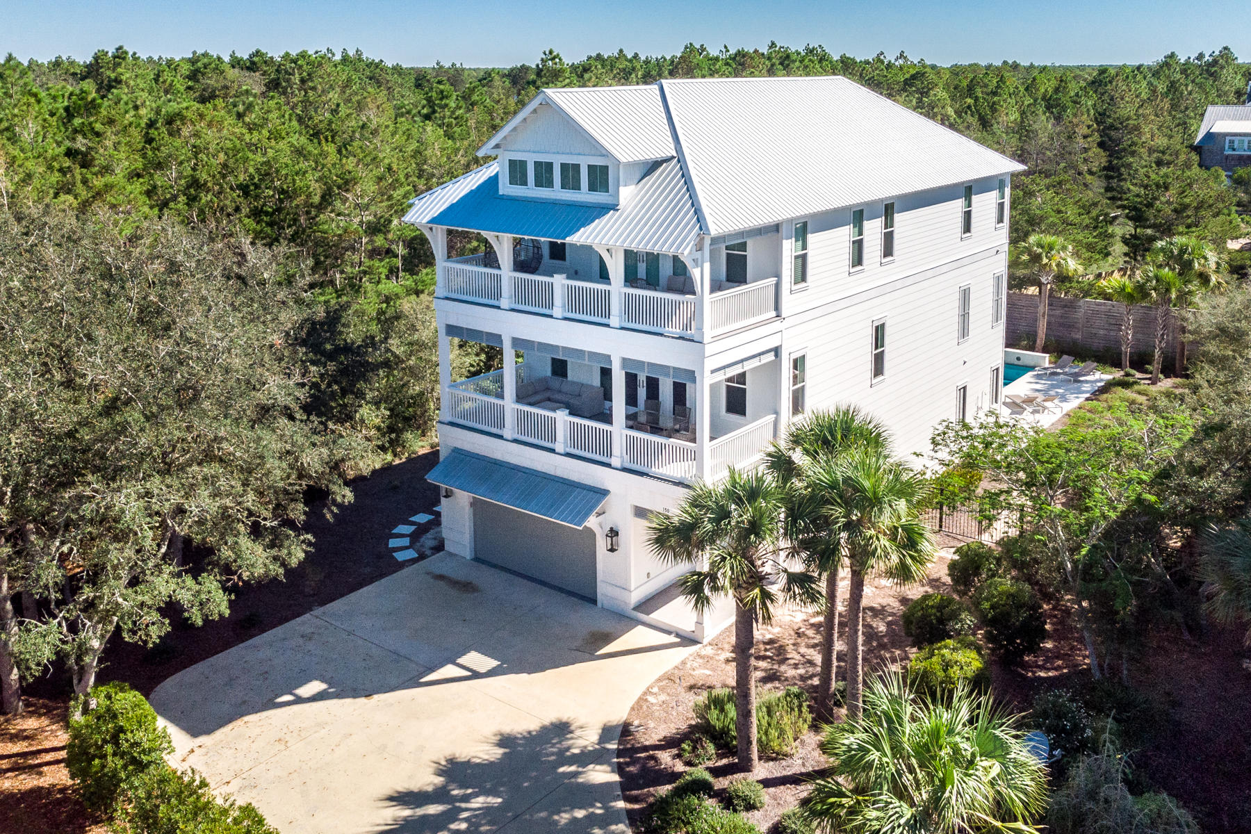 Beautiful, fully-furnished and semi-private home on oversized 1/4 acre lot adjacent to Camp Creek Golf Course in Seacrest with deeded beach access!. Built in 2018 by Cogent builders, this 5 bedroom home features on the ground floor a two car garage (golf cart included) with epoxy floors, a private pool, a fire table, and a large, screened entertaining area complete with summer kitchen and TV. Inside on the first floor, you'll find a generously sized bedroom with full bath, laundry room and a private elevator leading to the second and third floors. On the second floor is where family and friends gather in the open concept kitchen, living, and dining areas to laugh, watch games, and share stories!