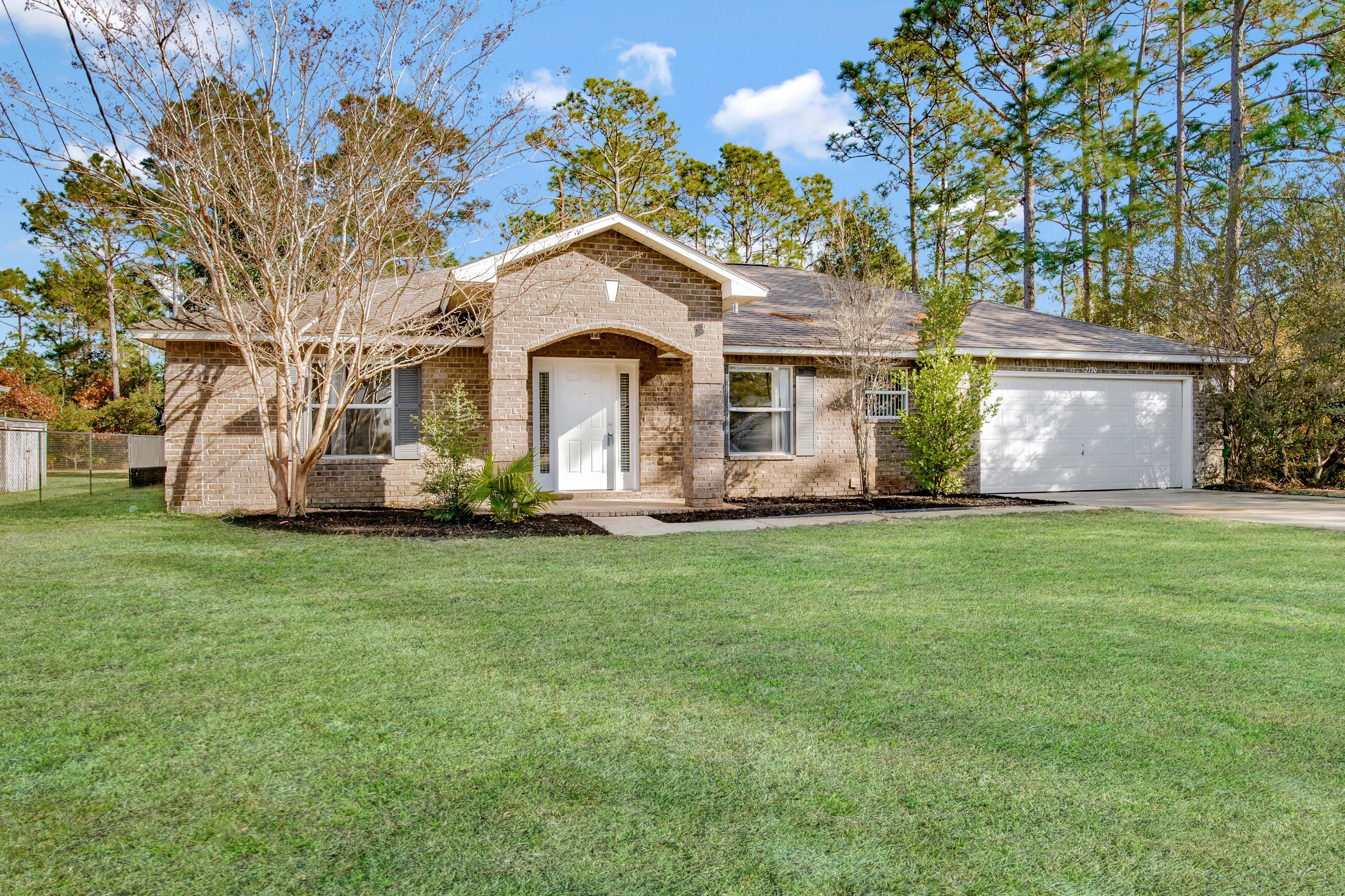Situated on a cul-de-sac in Holley By The Sea, this home offers 4 bedrooms and 3 full bathrooms with an open spacious floor plan with vaulted ceilings and a formal dining room and formal sitting room. The formal sitting room would also make for a great home office space, playroom or home gym. You'll enjoy the secluded shady backyard (lot goes back 300 feet with wooded area). The entire interior including trim and doors have been freshly painted with new vinyl plank flooring throughout the main living areas and bathrooms. The kitchen has an island with breakfast bar, breakfast nook and stainless steel appliances with a large pantry. Just off the pantry is an oversized laundry room with a utility sink. The master suite offers privacy located on the opposite side of the house from the additio