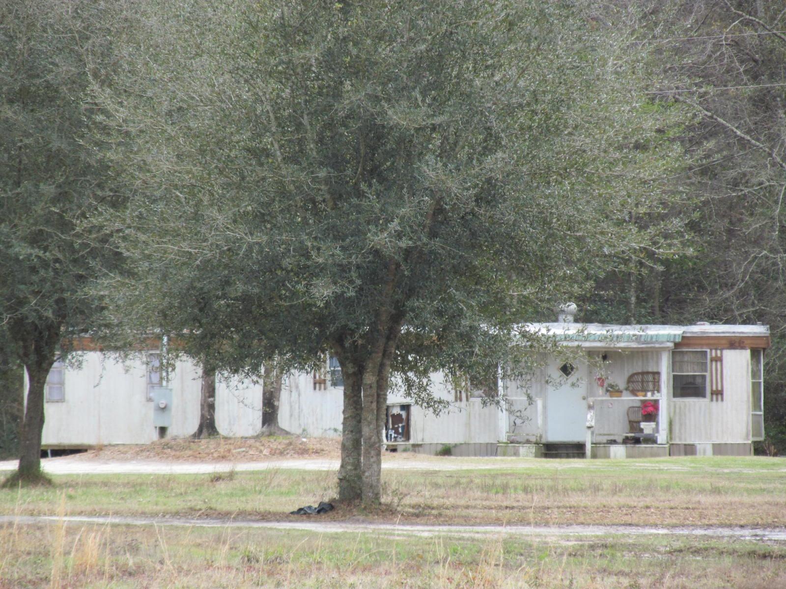 12 acres and three mobile homes. Property could make a nice home site or with a little TLC a smart rental investment. Each mobile has its own electric meter & water meter.