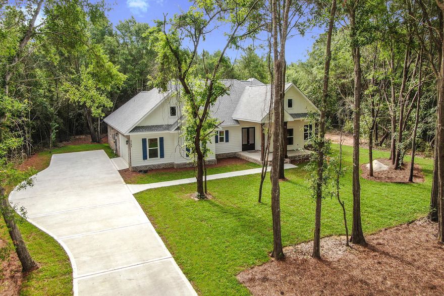 Stunning 4 bedroom, 2 1/2 bath, 2320 SF on 4.98 acres with custom details. Cypress wrapped columns lead to a grand 8' double entry door. Open split bedroom plan. Kitchen features: 4 x 8 granite island, gas stove, hood vent, custom shaker soft-close cabinetry, tile backsplash, granite countertops & huge walk in pantry with built in shelving. 5' windows throughout allow for plenty of natural light. LVP flooring (NO carpet) Master with handcrafted barn door leading into master bath, a walk in designer tile shower, separate soaking tub & dual vanities with handcrafted mirrors. Addtl bedrooms are spacious w ceiling fans. Covered back porch, ready for your outdoor kitchen: plumbing, gas and electric in place. Tankless gas water heater *Up to $7000 in Buyer Closing cost offered*