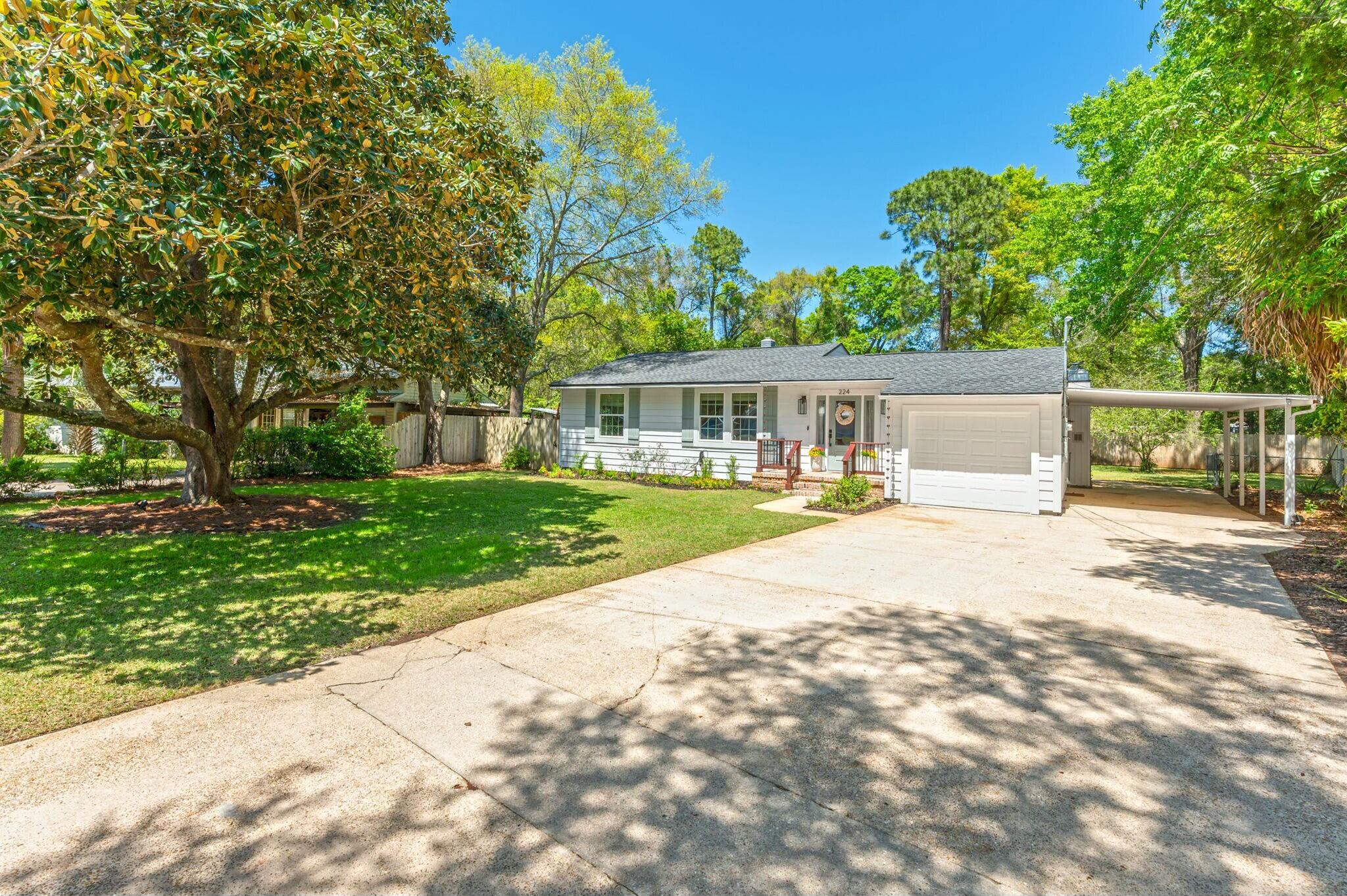 This Beautiful Florida cottage is on an oversized parcel that is truly a park like setting. It has undergone an extensive renovation and was completely gutted to the studs in 2021. Located in the popular Beachview/Garniers Beach neighborhood, you can enjoy walks to the water, park and beach that you can see from the front yard. The layout of the home was reworked in order to open up many of the spaces and to allow for more natural light to pour into all the rooms. The kitchen was transformed into a semi open galley style rather than a closed in kitchen.  Much of the original character and charm was preserved during the renovation process and now seamlessly blends with the new features creating the perfect mix of old and new. No expense was spared. All work was completed in 2021. Interior
Full Copper electrical rewire to include new panel and sub-panels. New switches and outlets.
New hardwired smoke and carbon monoxide detectors
New Can Lighting Installed
Fully Replumbed with Pex-Plumbing
New Gas Water Heater
New HVAC System with all new duct work. 
New blown in cellulose insulation
New Natural Gas Line from Outside to Kitchen Range
Natural Gas line to fireplace and capped for ease of future use
New Sheetrock with orange peel texture
Benjamin Moore Aura Paint throughout
New baseboards
New custom wood door & window casings on all windows, doorways and doors
New Fireplace Flue
New Irrigation pump 
Closets feature solid wood shelving
All new 2 panel craftsman interior doors
Solid 3/4 Inch White Oak Wood Flooring with Matte Oil Based Finished throughout living areas and master bedroom
Foyer wood set in a herringbone pattern
Tongue and groove wood ceiling in foyer with lantern and ceiling medallion
New Driftwood carpet and pad in 2 other bedrooms (2025)
Custom Solid wood walls in living room and foyer
Stained real wood beams in living room and kitchen
New matte black hinges and doorknobs
All new lighting and ceilings fans

Kitchen
New Shaker Wood Kitchen Cabinets with soft-close drawers
Custom Built Microwave Cabinet
Light Level 5 Granite with grey veining
New Samsung Stainless Steel Appliances to include 5 burner gas range with griddle
Matte Black knobs and pulls
Zellige Ceramic Tile Backsplash
Stainless Steel Ranch Hood
Custom butcher block floating shelves
Matte Black and brass sconce lighting
Stainless steel farmhouse sink with built in cutting board and grate accesories

Bathrooms
Highly custom and special order handmade zellige tiles for shower walls
Mini penny and hexagon tiles on floor and 12x24 custom fan tile in master
2 wood vanities
All new Delta Trinsic plumbing fixtures in champagne bronze or matte black.
Framless Shower glass with special order bronze hardware
Matte wood framed mirror
All new bathroom lighting and vent fans
Master bathroom features an oversized linen closet with restored louvered door
Hall bathroom features a 4 way showerhead with hand sprayer
New Toilets

Exterior
New Dimensional 30 year Shingle Roof
All new double paned Low- E glass windows with French pattern grids
New Sliding Glass doors
Custom addition of front porch with real Old Chicago Brick laid in a herringbone pattern with custom iron and wood railing.
Matching old Chicago brick mailbox
New oversized outdoor lantern lighting
New 3/4 Lite Front door with double side light units
New Garage door and opener
Blend of both Aluminum lap siding and vinyl board and batten siding
New Irrigation system with new sprinkler pump, well and timer
New Palisade Zoysia Turf Grass throughout entire lot
Custom landscaped beds featuring purple muhly grasses, ornamental grasses, lilies, roses and longleaf pinestraw
364 Feet of New 6 ft wood privacy fence and gates
New Oversized rear screen porch with 2 new screen doors & wood deck
New exterior hose bibs
Copper Rain Chains
New French Drain in driveway
Mature Trees that have been professional pruned and trimmed

Location
Oversized 1/3 acre lot with large backyard
Walking distance to waterfront park with playground, boat ramp, sandy beach, bathrooms and picnic tables

Other Notable Features:
No restrictions on short term rentals