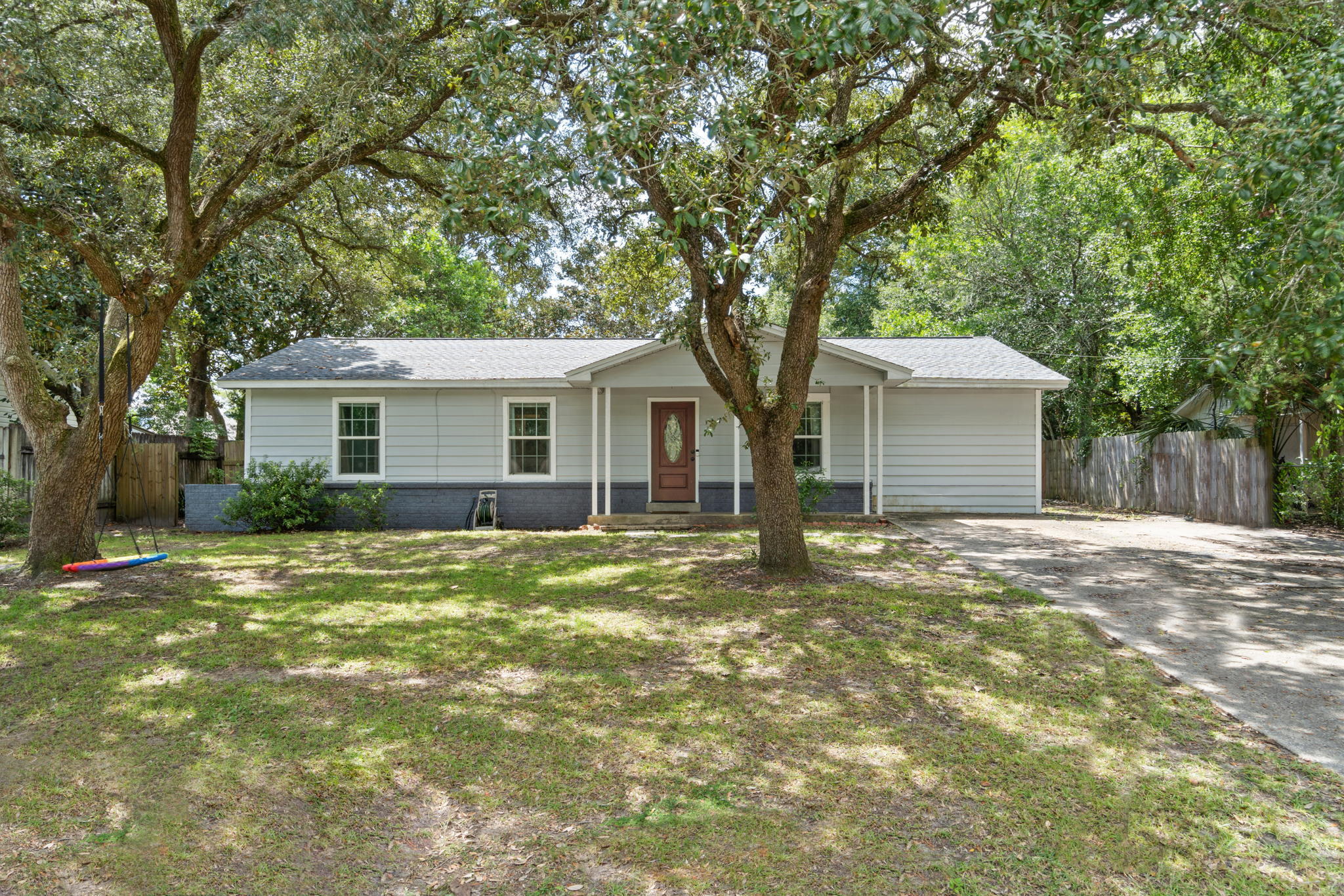 Welcome home to this perfectly located 4 bedroom, 2 bath Fort Walton Beach home that has been completed and beautifully renovated from top to bottom! It was built in 1960 but as an effective date of 2000 thanks to all the updates! Have peace of mind with updated copper wiring and a roof, water, heater, and HVAC system that were all replaced in 2018. Located on a 0.21 acre lot you have a great sized backyard complete with backyard storage building. Inside your jaw will drop at the stunning updates and you'll love the hard surface flooring all throughout the home - no carpet at all! The living room opens to the dining space where you'll find a beautiful kitchen featuring white shaker style cabinets, stainless appliances, granite counters, lovely natural wood open shelving, a pantry, and